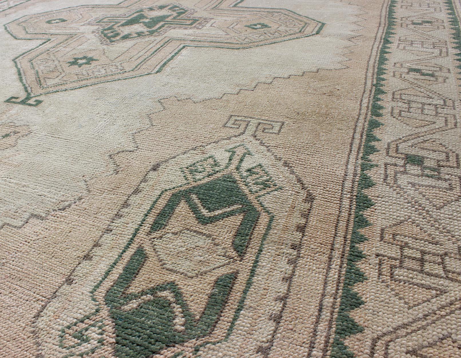 Wool Tribal Turkish Oushak Rug in Green, Light Peach and Cream with Cross Medallion For Sale