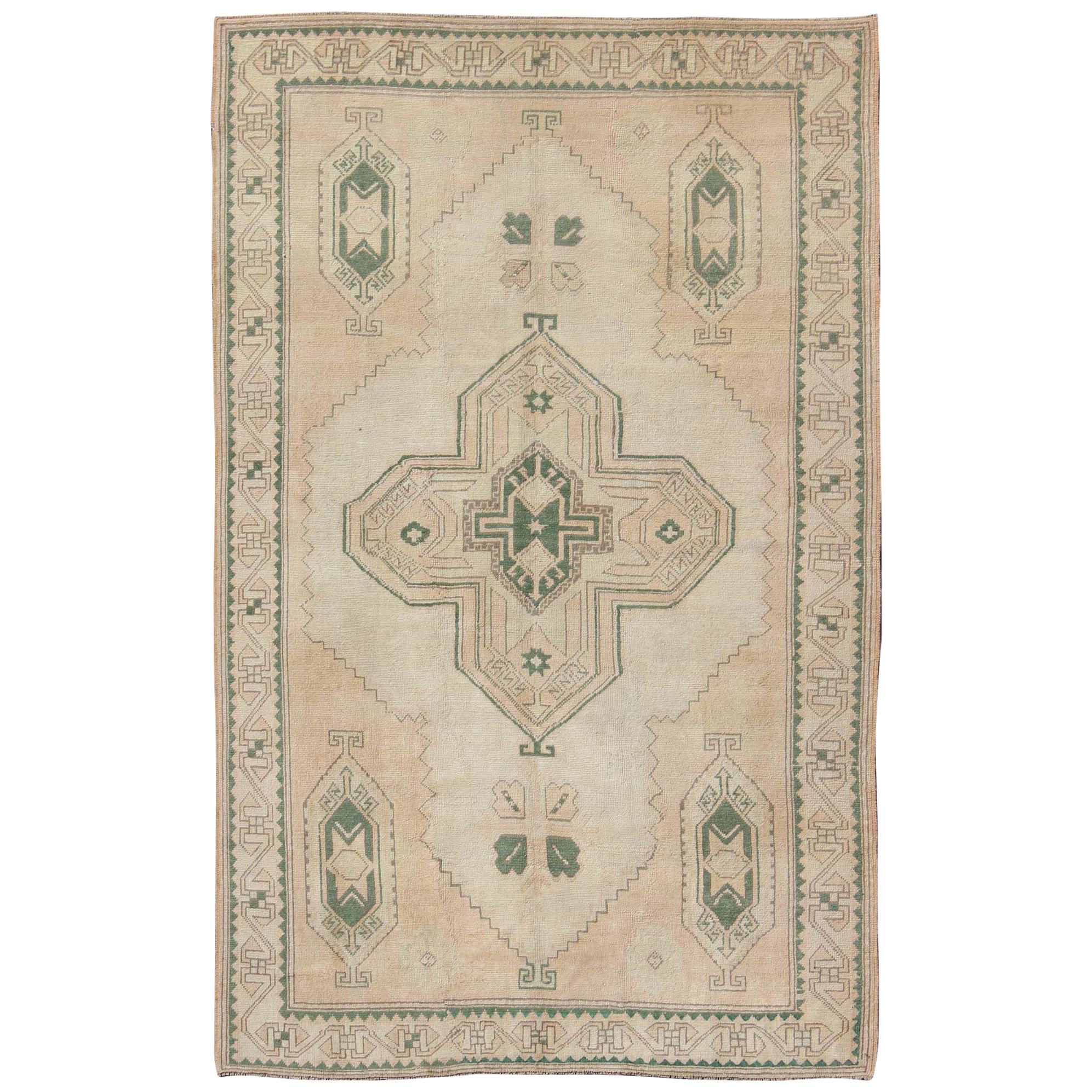 Tribal Turkish Oushak Rug in Green, Light Peach and Cream with Cross Medallion For Sale