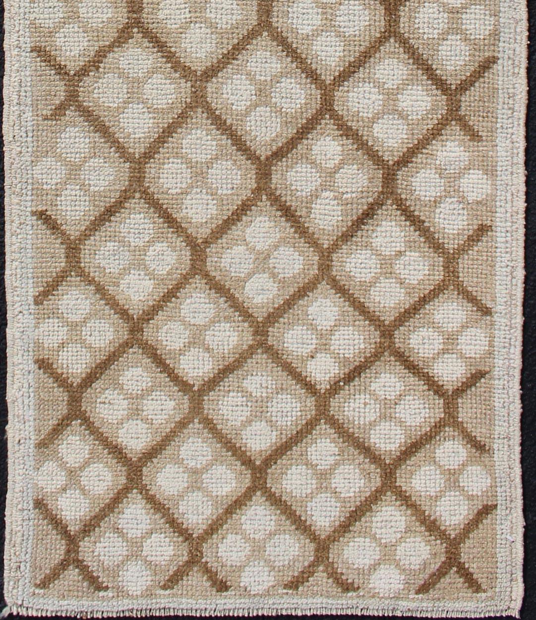 Measures: 2'1 x 6'7.
This lovely Vintage Oushak Runner features an all-over diamond design rendered in hues of cream and accentuated in shades of brown. This rug is finely suited for a variety of modern, transitional, classic and casual