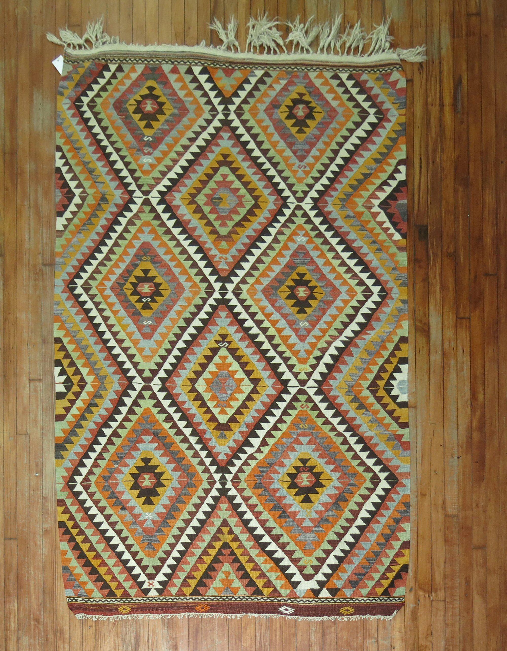 A vintage geometric Turkish Kilim accent-size rug from the mid-20th century.

Measures: 5' x 7'5''.