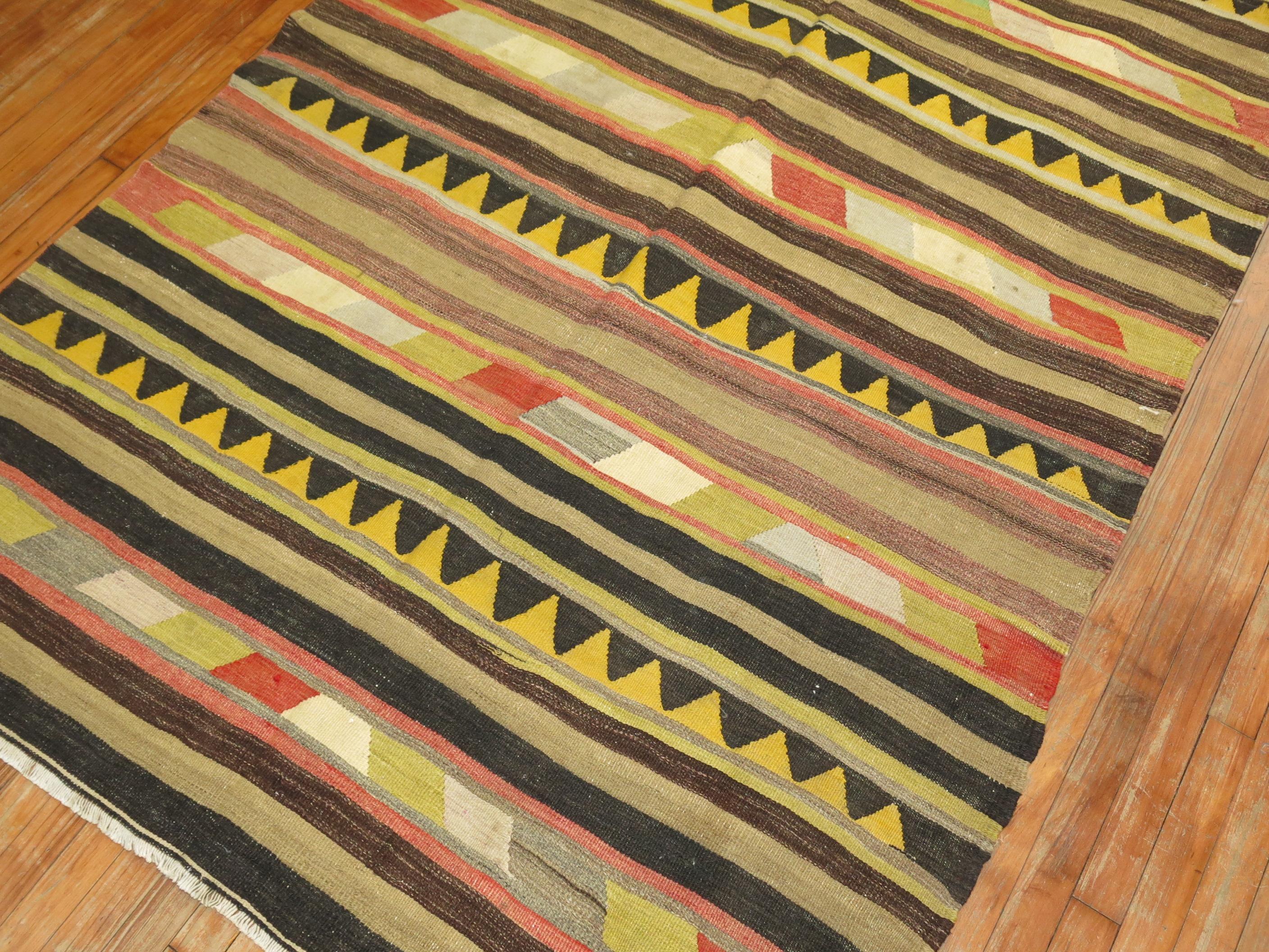 Primitive Tribal looking Turkish Kilim flat-weave from the mid-20th century. 
Soft browns, yellows, reds are the main colors.

Measures: 5'1