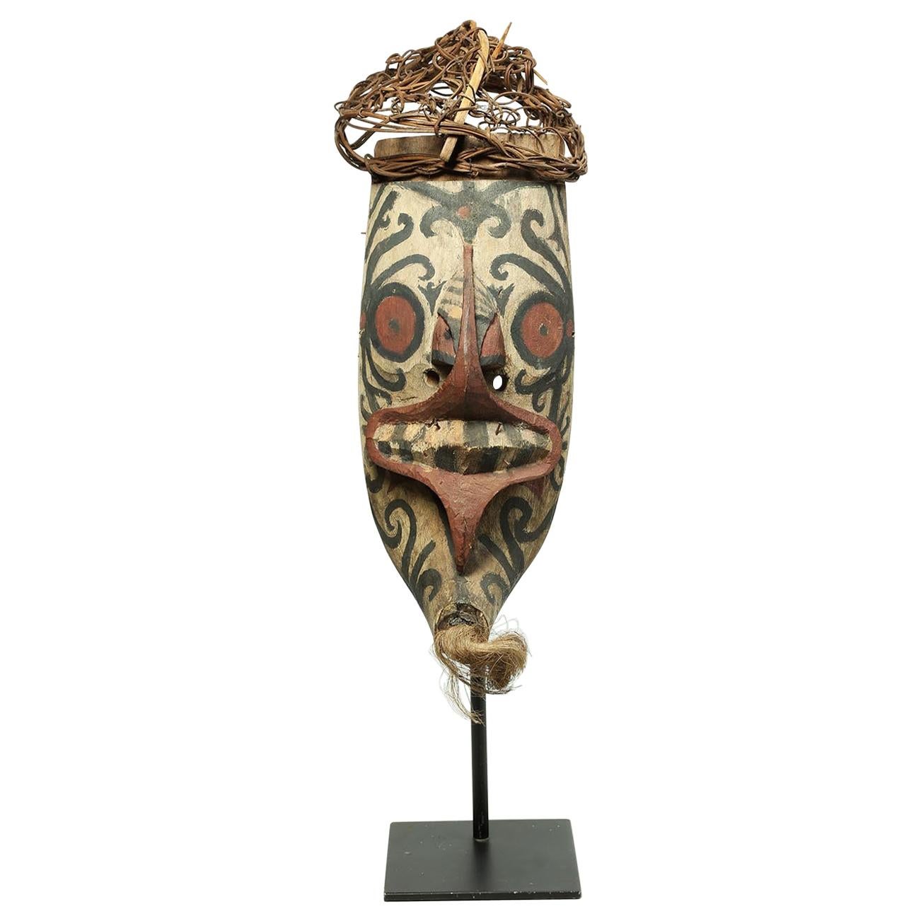 Tribal wood and pigment Borneo Dayak Hudoq mask on stand, Indonesia, early 20th century
Painted wood Dayak Hudoq tribally used mask with remains of black, red and white pigments. Part of headdress still attached, and fibers in chin, early 20th