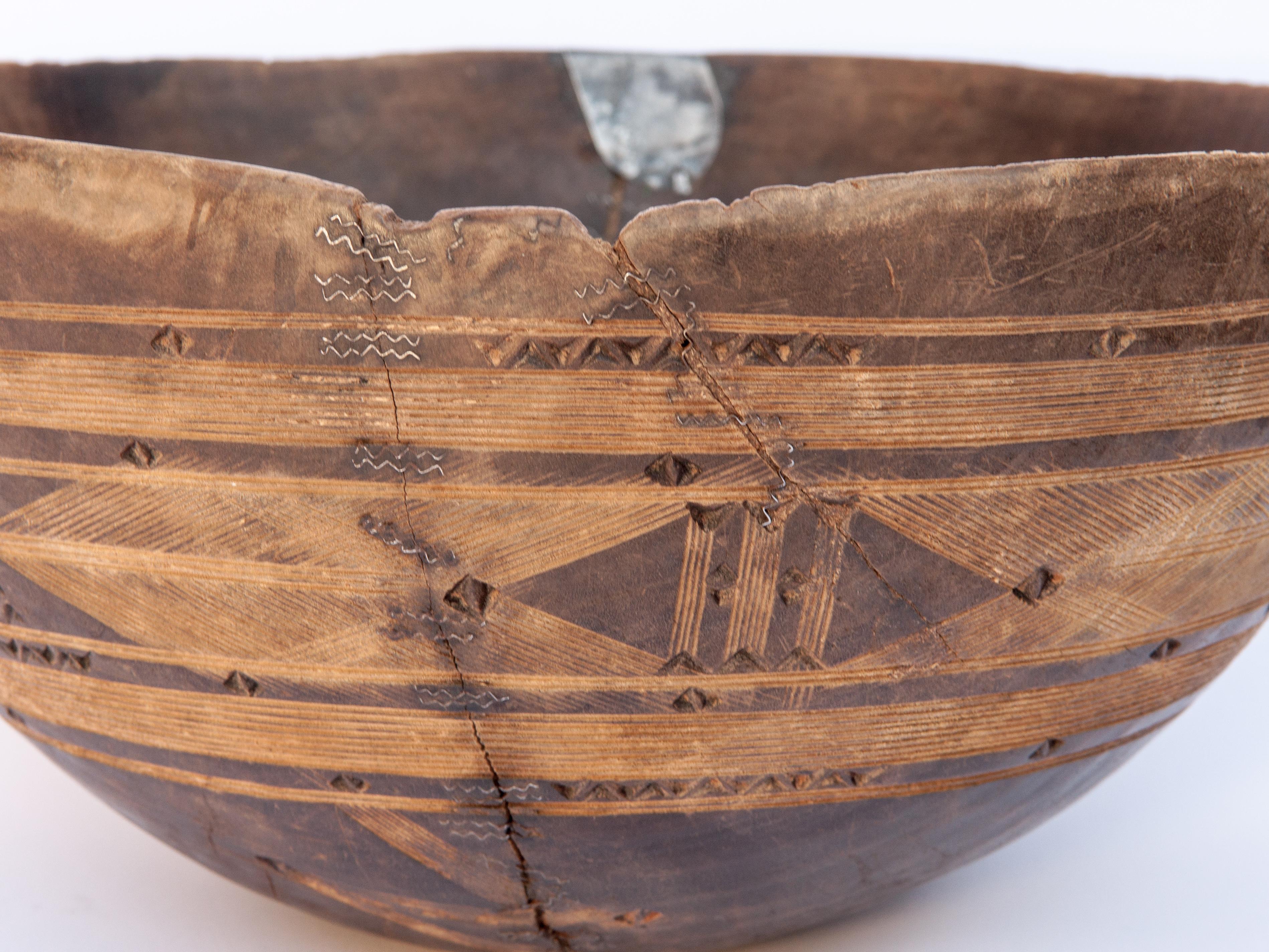 Tribal wooden bowl with carved design, 14