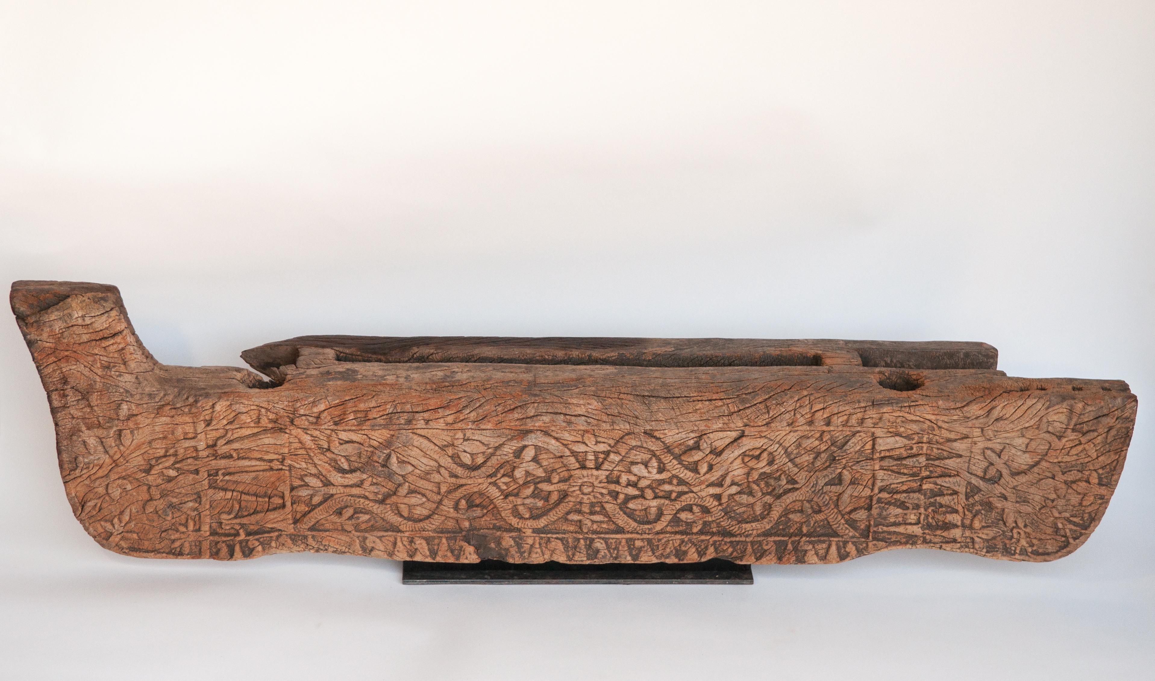 Tribal wooden carving from a door threshold. Flores, Indonesia, early-mid 20th century. Mounted on a metal and wood base.
This carving comes from Flores Island in East Indonesia, most likely from the Ngada Regency of central Flores. It served as