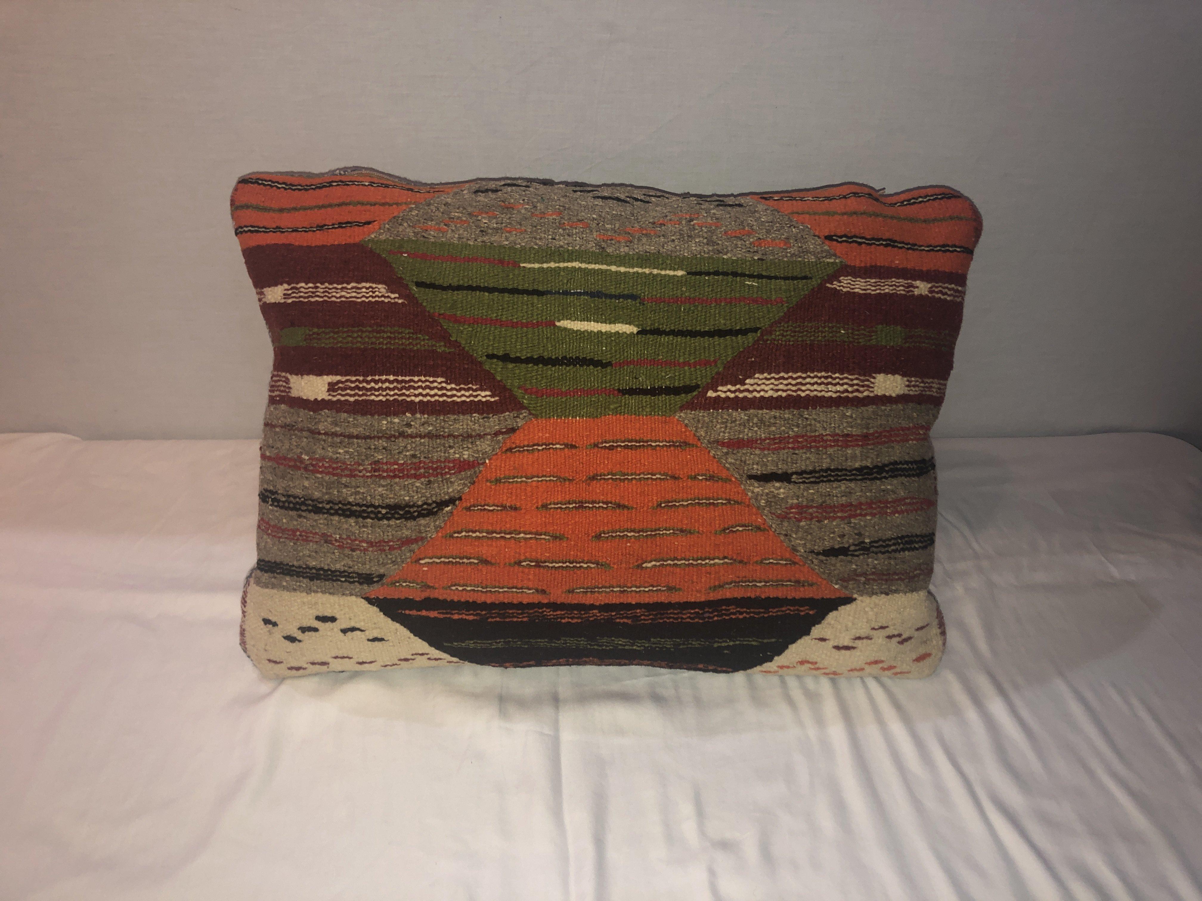 A stunning one-of-a-kind Kilim pillow, custom made from a vintage Moroccan wool rug handwoven in the Atlas Mountains in Morocco by Berber women artisans. This beautiful Kilim pillow will look great in any interior style such as Bohemian, Classic or