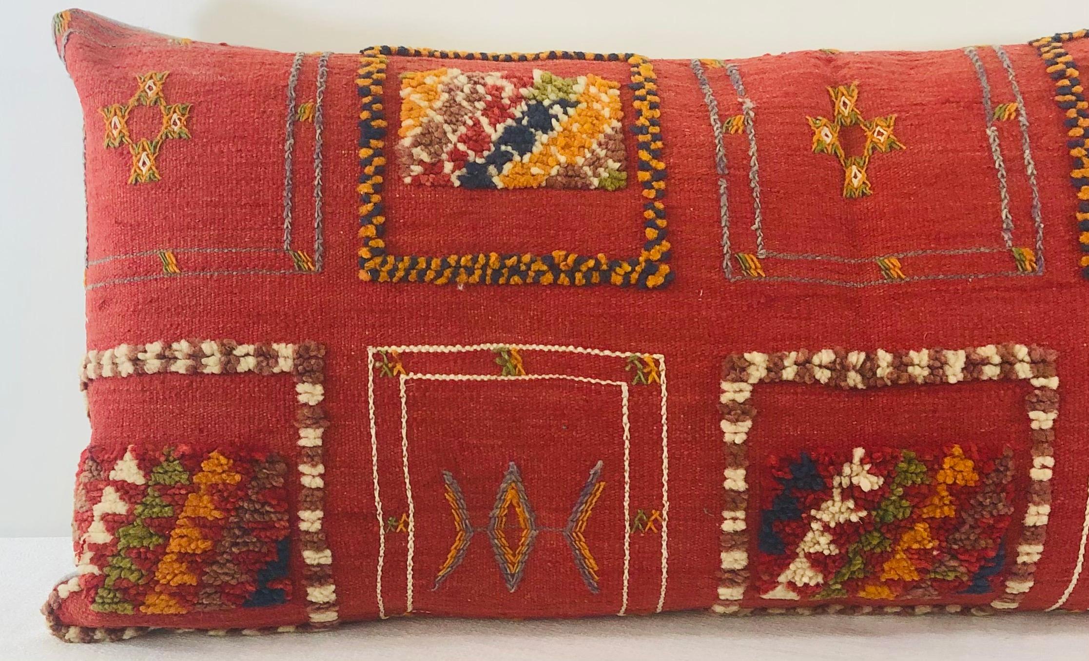 Featuring vivid and earthy burgundy, blue, off white and green colors, this stunning one-of-a-kind Kilim pillow is custom made from a vintage Moroccan wool rug handwoven in the Atlas Mountains in Morocco by Berber women artisans.

This beautiful