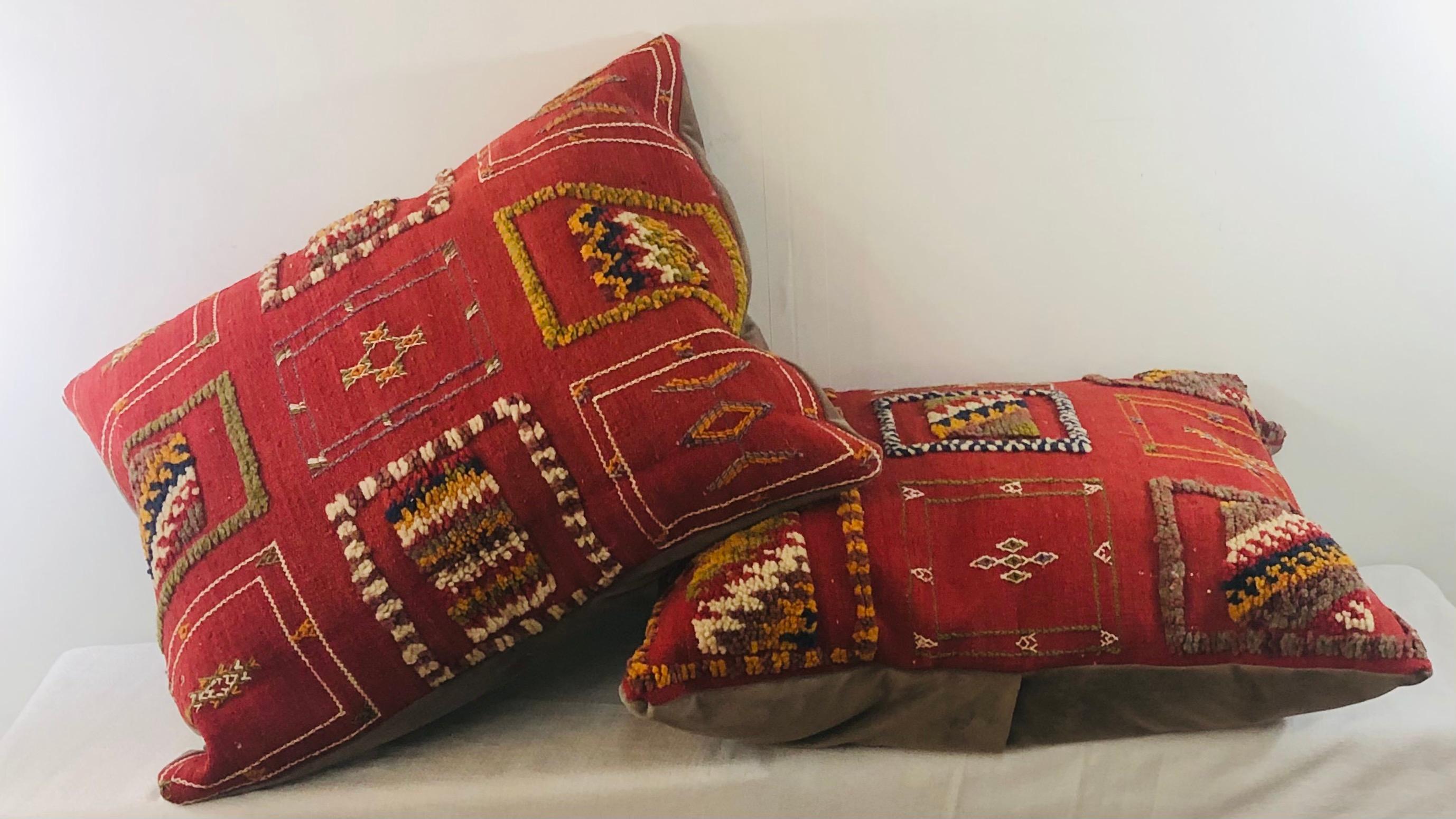 Featuring vivid and earthy burgundy, blue, off white and green colors, this stunning one-of-a-kind pair of Kilim pillows are custom made from a vintage Moroccan wool rug handwoven in the Atlas Mountains in Morocco by Berber women artisans. Panels