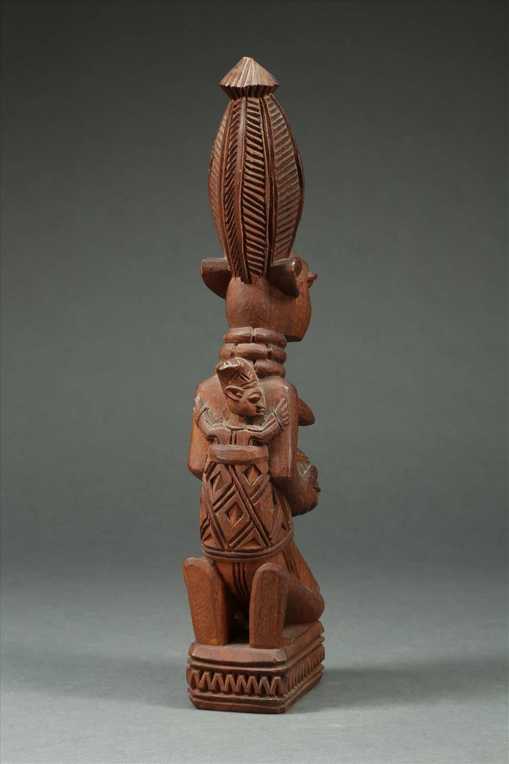 Offered by Scott McCue
Tribal Yoruba maternity figure holding a bowl, Signed J.A. Fakeye, Nigeria

A kneeling Female Yoruba figure with tall hairstyle and child in wrap on back reaching around mother. Signed on base J.A. Fakeye. 15 3/8