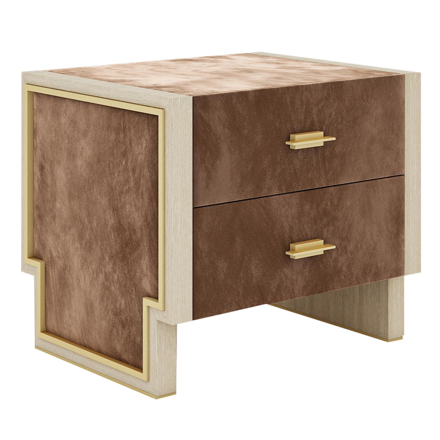 Perfect to suit a lavish and polished bedroom decor, this unique nightstand features a wooden structure covered in prized leather equipped with two drawers. The profile of this piece boasts a T-shape framed by a brass-finished metal detail and