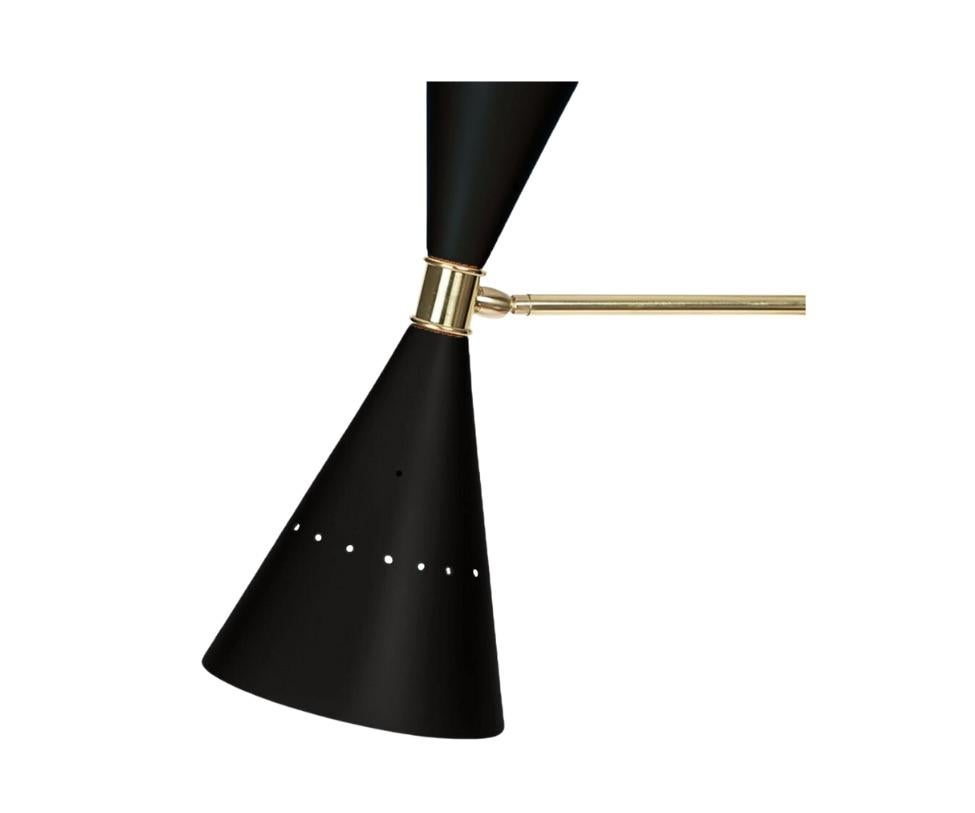 This black wall lamp is crafted of brass and composed of two cone shades. Reflecting light to both the north and south, this lamp is adaptable to any space.