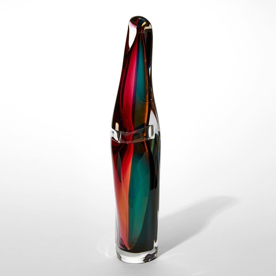 'Tricolarial 40' is a unique handblown sculptural vase by the British artist Vic Bamforth. With soft, twisting lines, the form has dynamic movement, which causes the colours to merge and move when viewed from differing angles.

Bamforth is an artist