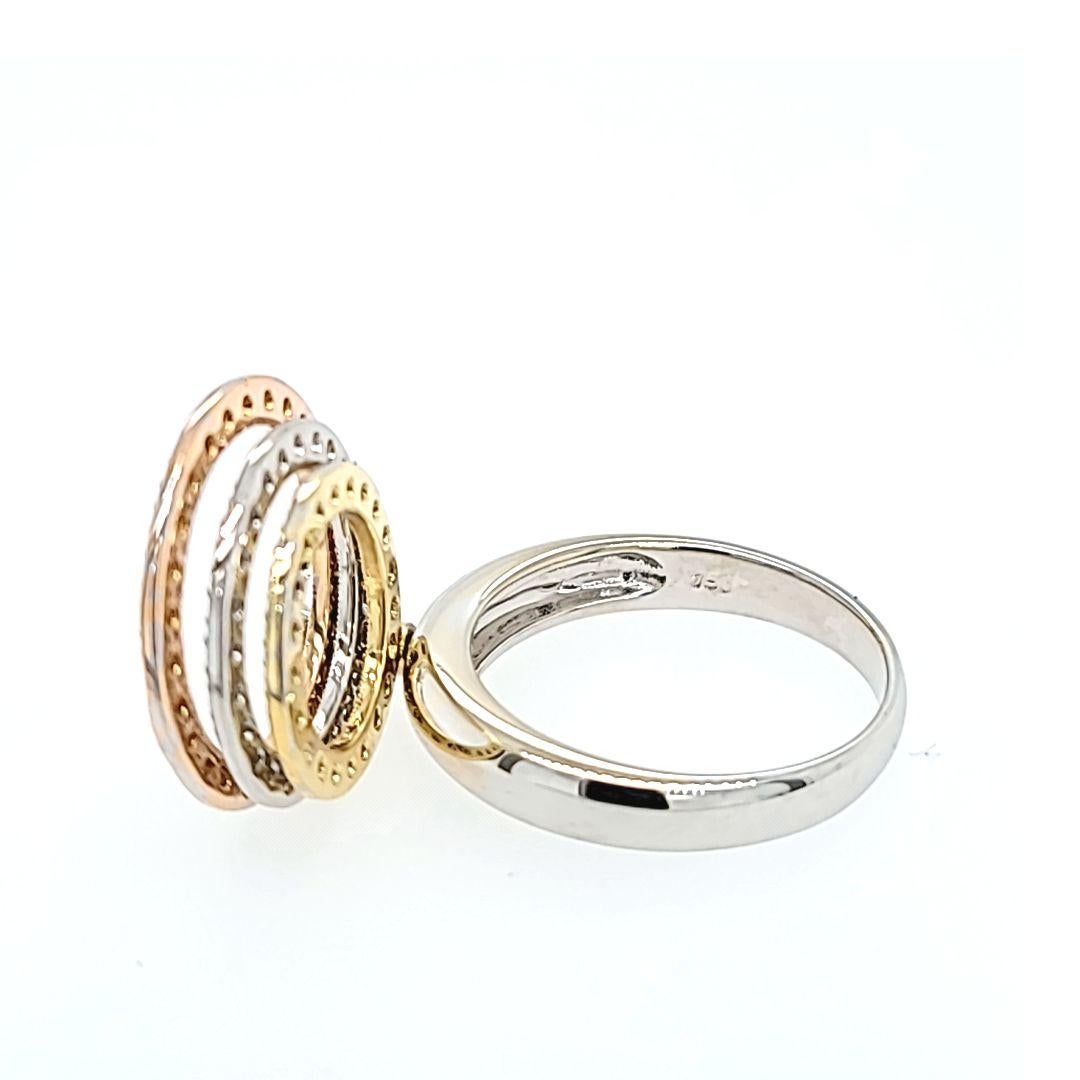 18 Karat Tri-Color Gold Spinning Ring Featuring 73 Round Diamonds of SI Clarity and H/I Color Totaling Approximately 0.36 Carats. Three Concentric Circle Design with Millgrain Edge Detail. Finger Size 7.25; One sizing service upon request, prior to