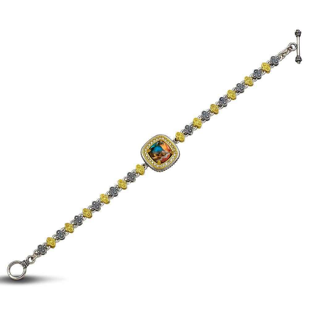 From the Nature collection, an exceptional sterling silver bracelet with a mosaic of various stones in a gold plated ornate bezel.
The has a clasp that can be adjusted to fit your wrist.
