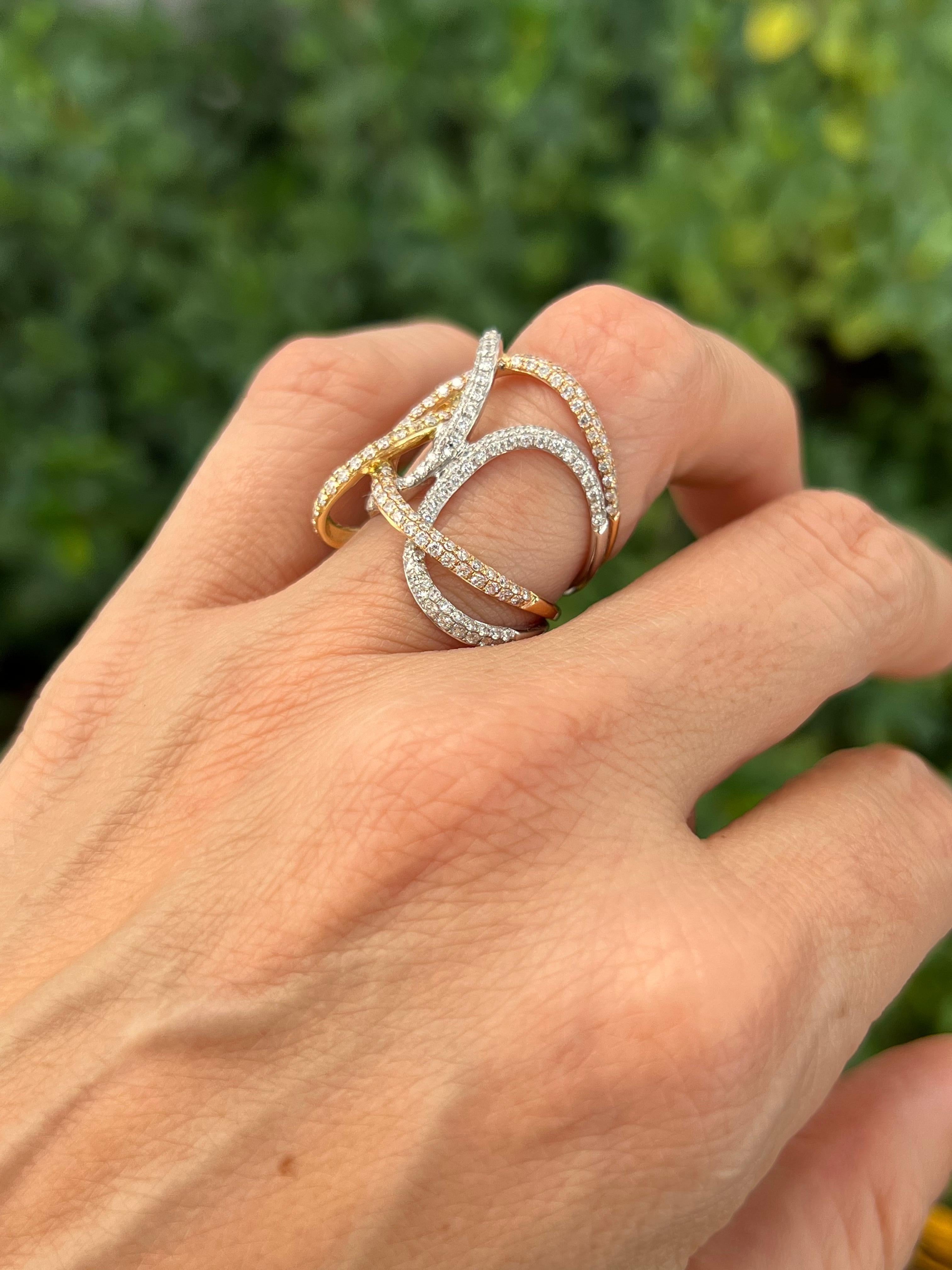 18K tricolor wide diamond band with 1.55 carat total weight in diamonds. Enjoy a wide full 24mm band with fluid movement that tapers around the finger to 6mm for a more comfortable fit. 

Features
18K tricolor gold
1.55 carat total weight
Ring size