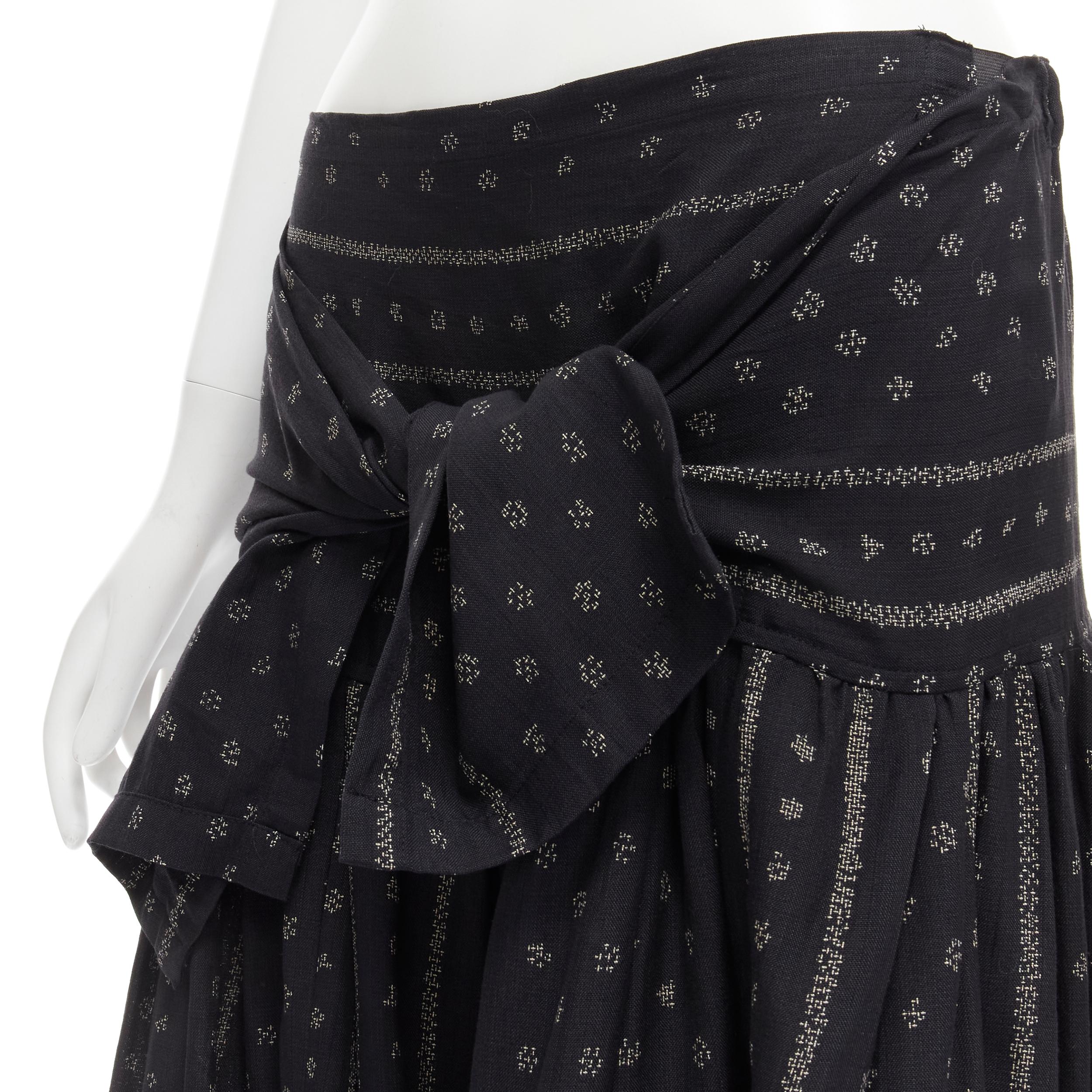 TRICOT COMME DES GARCONS black Ethnic Bohemian floral jacquard flared skirt S 
Reference: CRTI/A00487 
Brand: Comme Des Garcons 
Designer: Rei Kawakubo 
Material: Cotton 
Color: Black 
Pattern: Floral 
Closure: Tie 
Extra Detail: Elasticated waist.