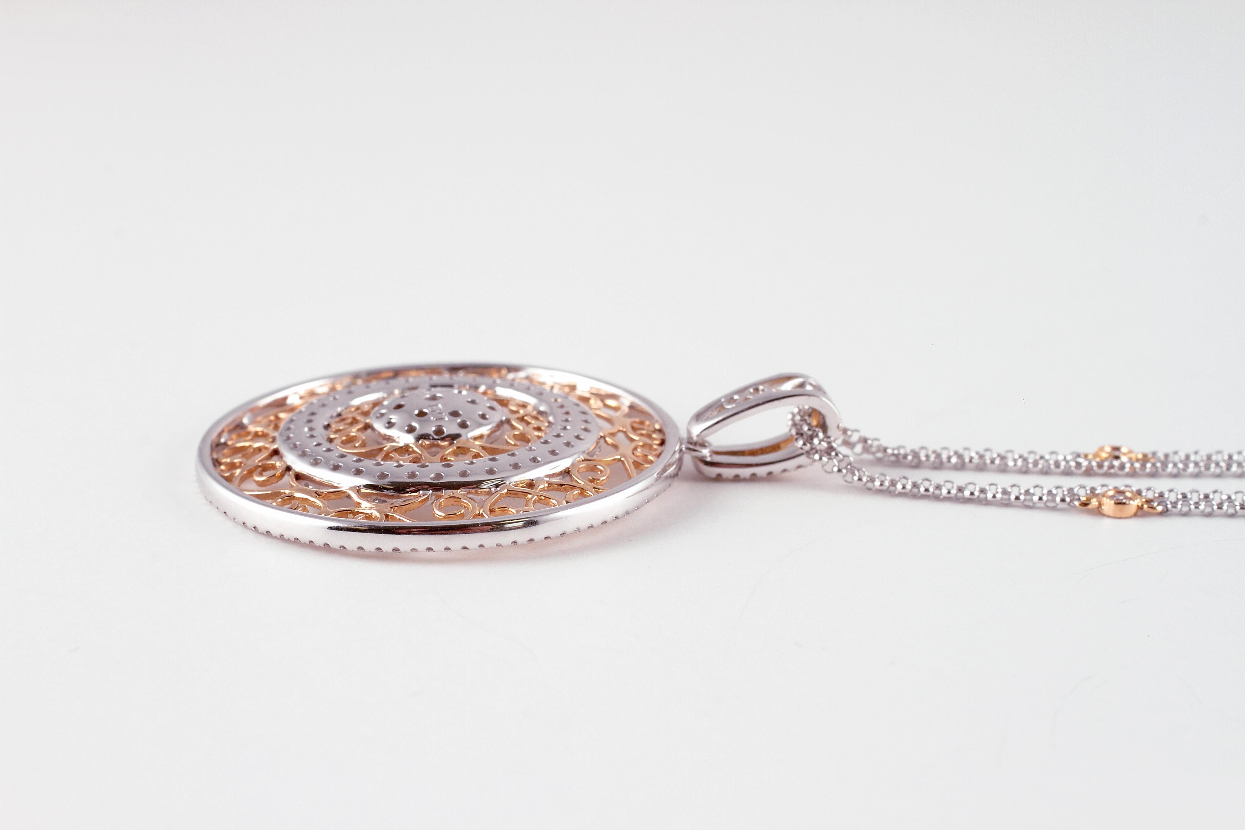 So versatile and light weight!  The 18 karat yellow and white gold , double link chain supports bezel-set, diamonds and the yellow and white gold, circular, filigree style pendant supports 2.30 carats of diamonds.  The diamonds are stated to be VS 1