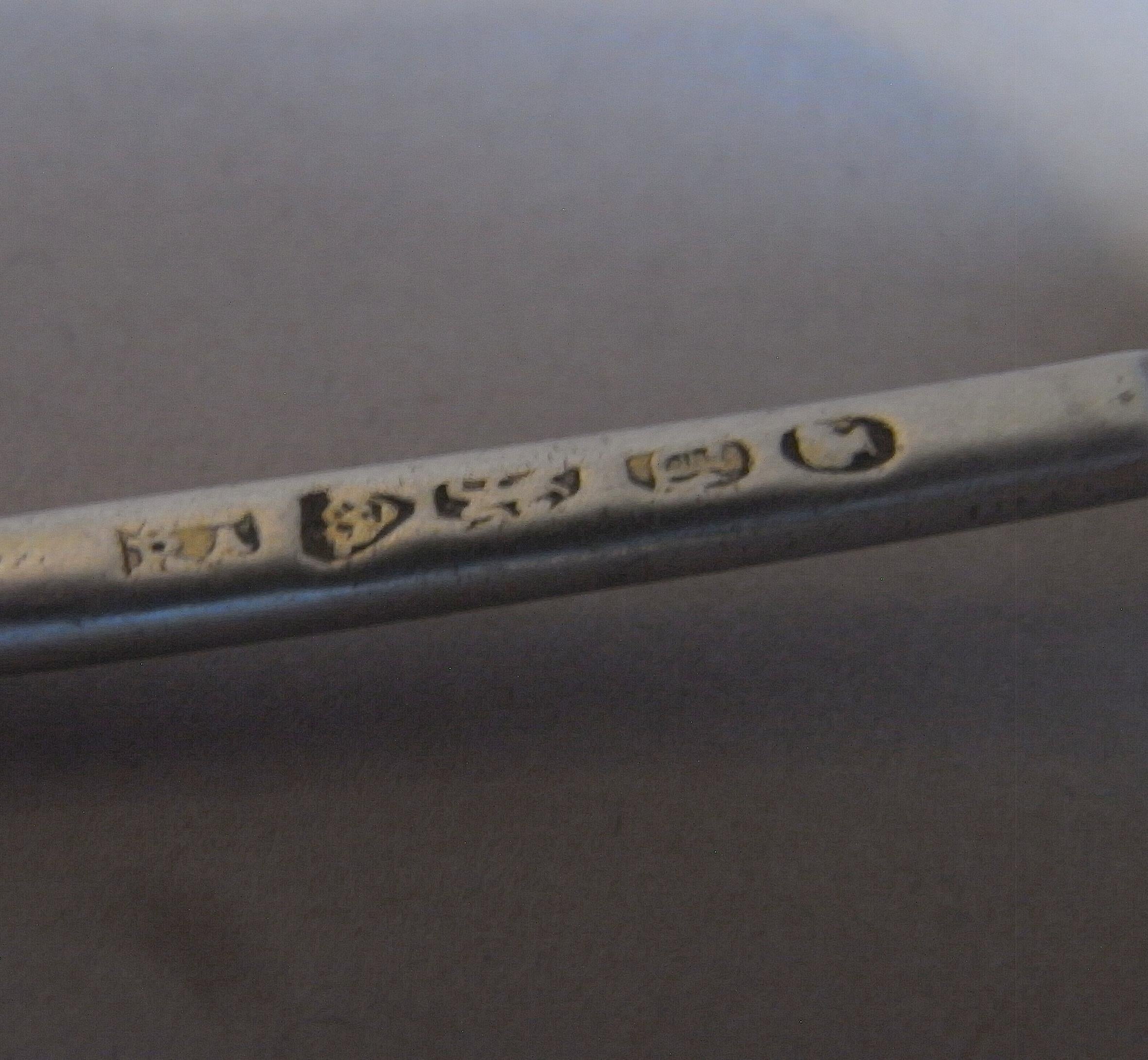 A Very Rare Cast Trident Condiment Ladle Made in London in 1839 by William Theobalds & Robert Atkinson.

The ladle has a deep shell bowl and the stem is modelled as a trident with two dolphins between its tines.  This was a design which was first