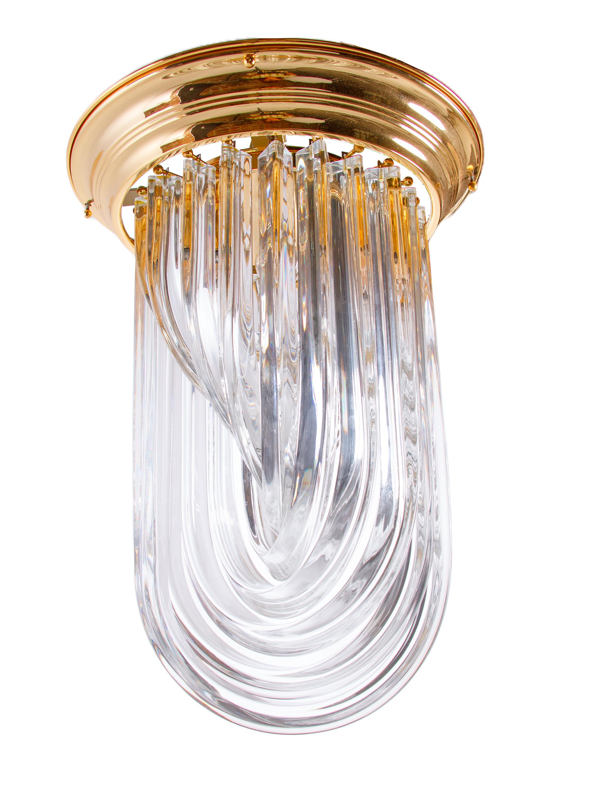 Amazing flush mount chandelier crafted in curved molded Murano Glass on a gilded brass frame. Chandelier illuminates beautifully and offers a lot of light. Gem from the time. 
With this light you make a clear statement in your interior design. A