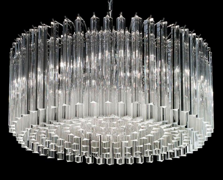 Italian chandelier with clear Murano glasses cut in Triedri technique arranged in nine layers on chrome finish metal frame by Fabio Ltd / Inspired by Venini / made in Italy
8-light / E12 or E14 type / max 40W each
Measures: Diameter 29.5 inches,