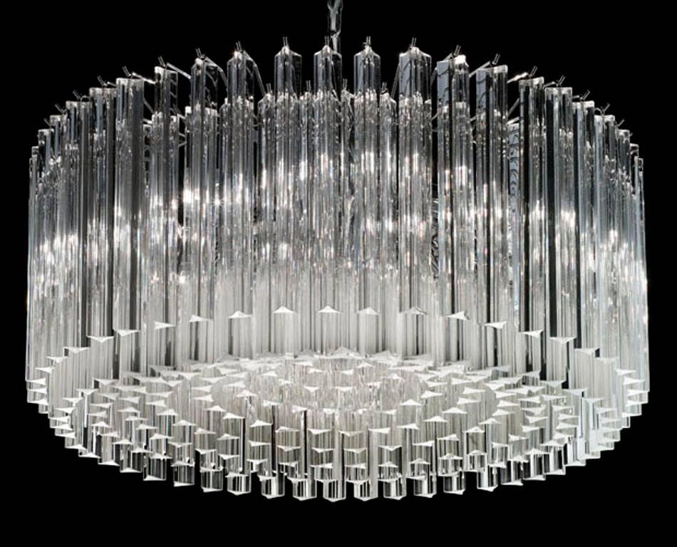 Italian chandelier with clear Murano glasses cut in Triedri technique arranged in nine layers on chrome finish metal frame by Fabio Ltd / Inspired by Venini / Made in Italy
8 lights / E12 or E14 type / max 40W each
Diameter: 29.5 inches / Height: 13