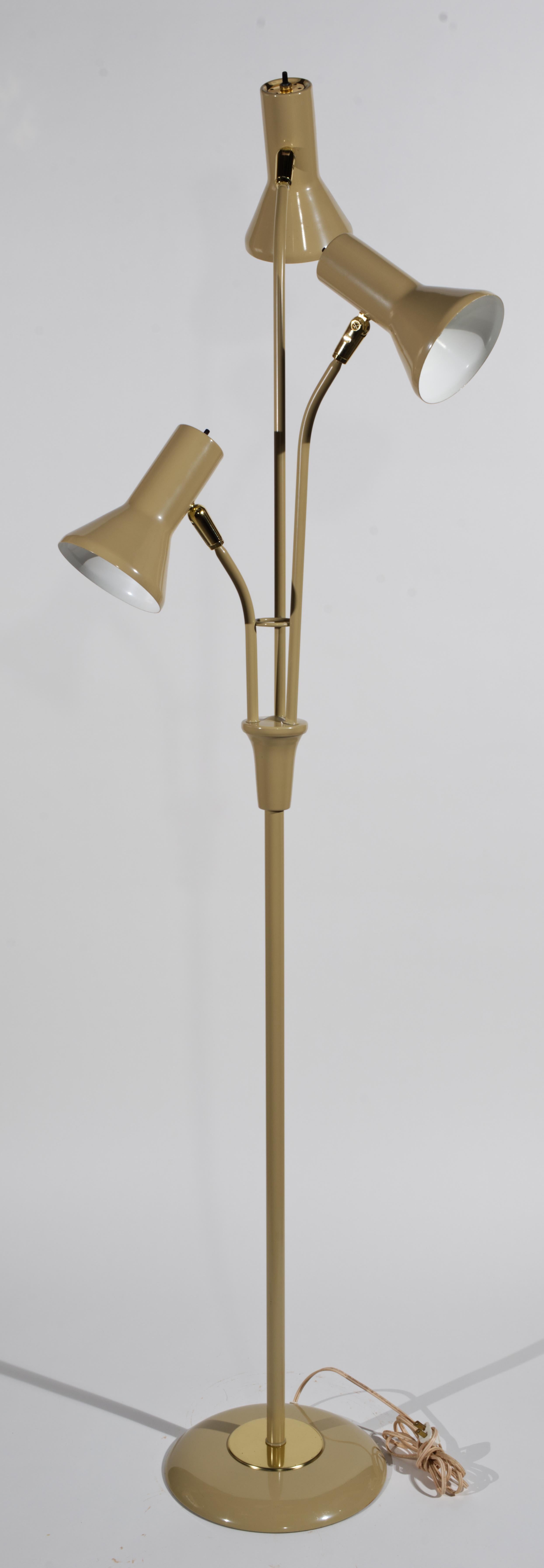  Sculptural floor lamp attributed to Gerald Thurston for Lightolier features a dramatic atomic era 3-light design in soft mocha brown enamel on metal with brass accents. Having three adjustable shades allows the user to position the light exactly