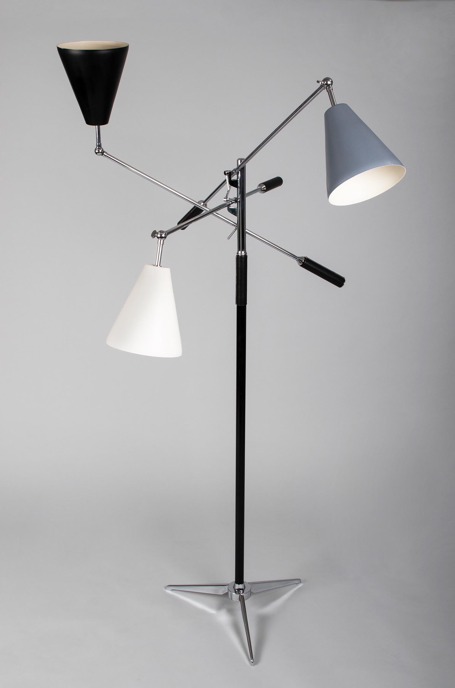 Italy, 1950s 

An architectural triennale floor lamp in the style of Angelo Lelii (sometimes spelled Angelo Lelli) for Arredoluce, with three moveable cone-shaped shades enameled in white, grey, and black. Supported by a partially leather-clad shaft