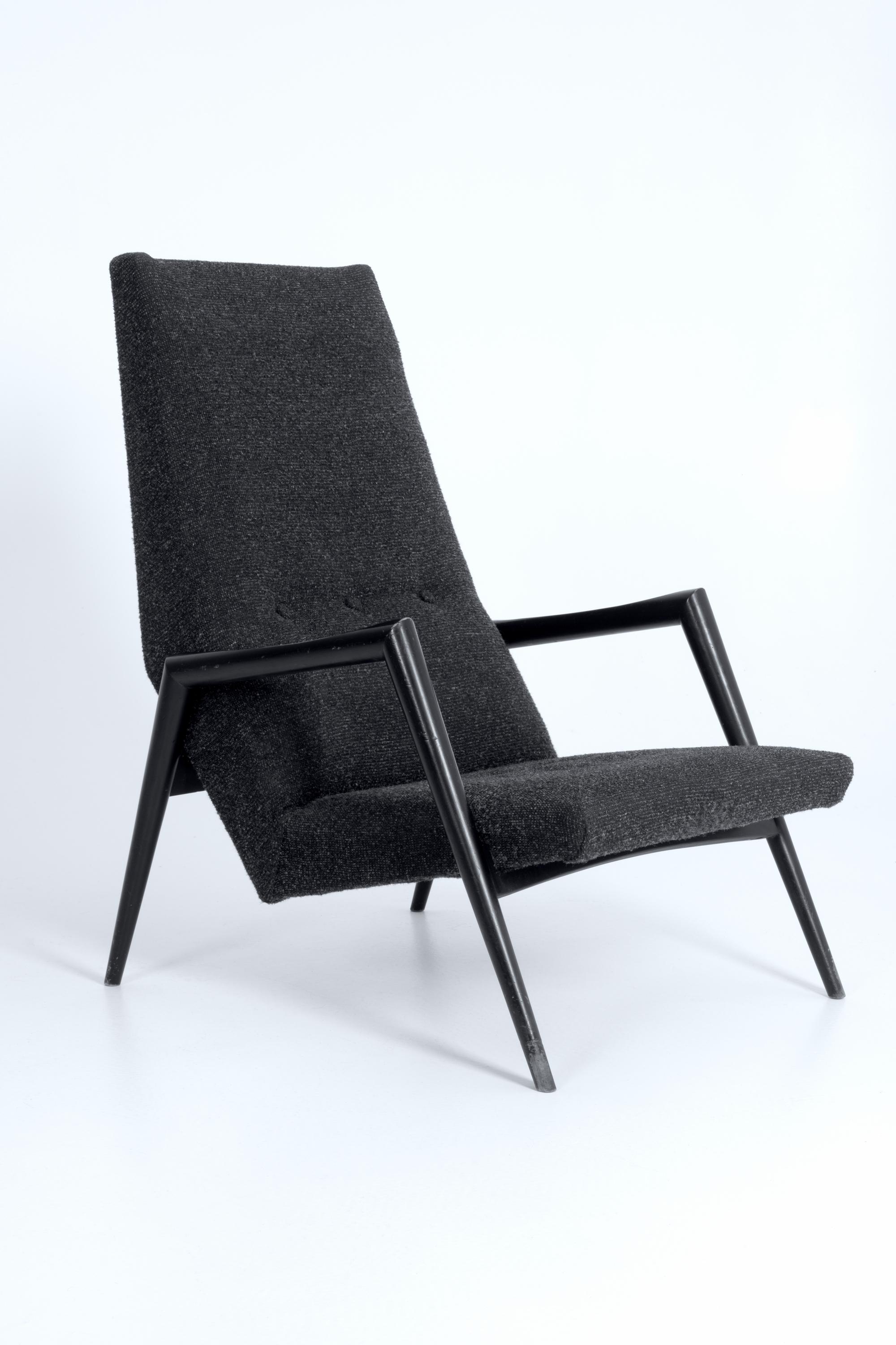 A 'Triennial' high back chair in original condition. This Dutch design by Rob Parry for the manufacturer Gelderland dates from 1953.
The chair has a solid round black lacquered beech frame with flattened armrests and grey fabric upholstery which is