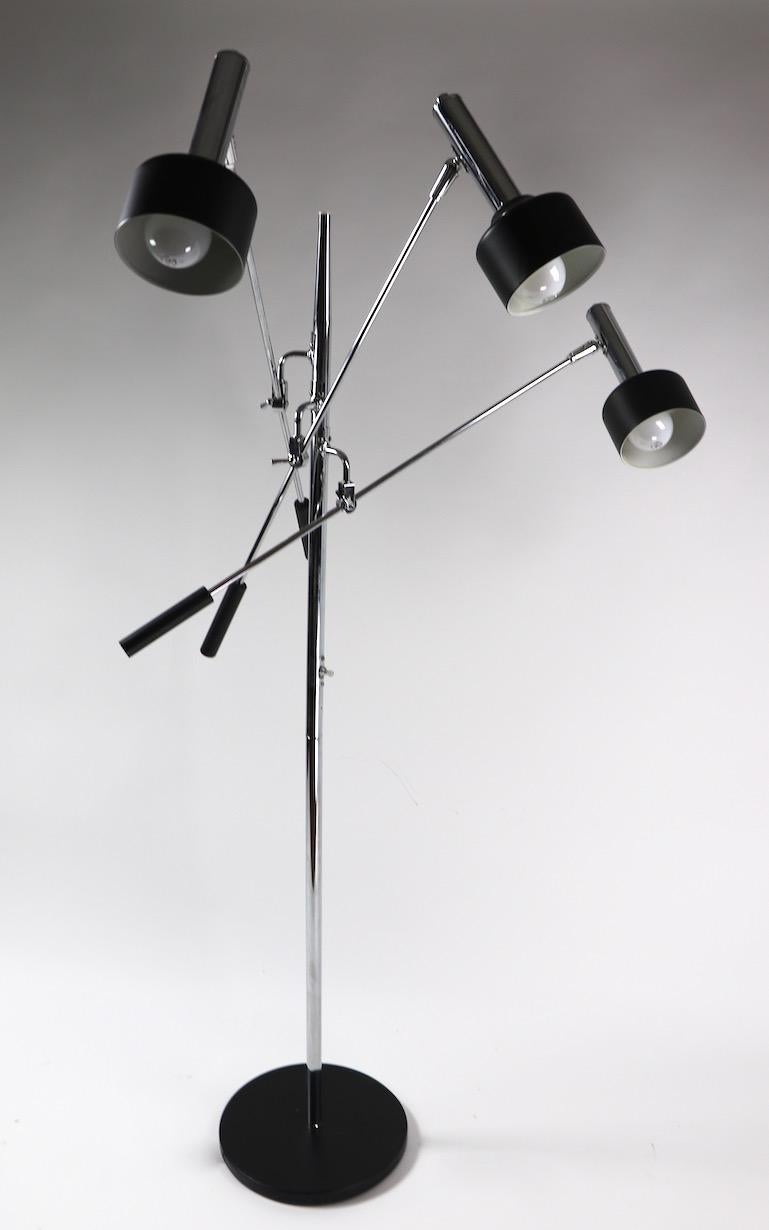 Classic black and chrome Triennale model floor lamp by Robert Sonneman, circa 1970s. This example is in very fine, original and working condition, having three chrome arms which adjust, each arm supports a hood shade which also adjusts in position