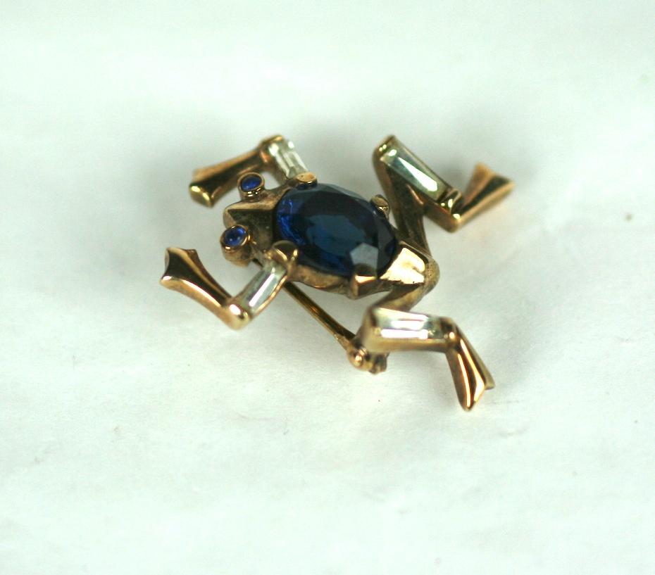Trifari Alfred Philippe collectible miniature frog brooch in gold plate base metal,  crystal rhinestone baguettes and faux sapphires. Signed Trifari with Crown, Pat Pend. 
Designer A Philippe, dated 1949
Excellent condition.
Length 1