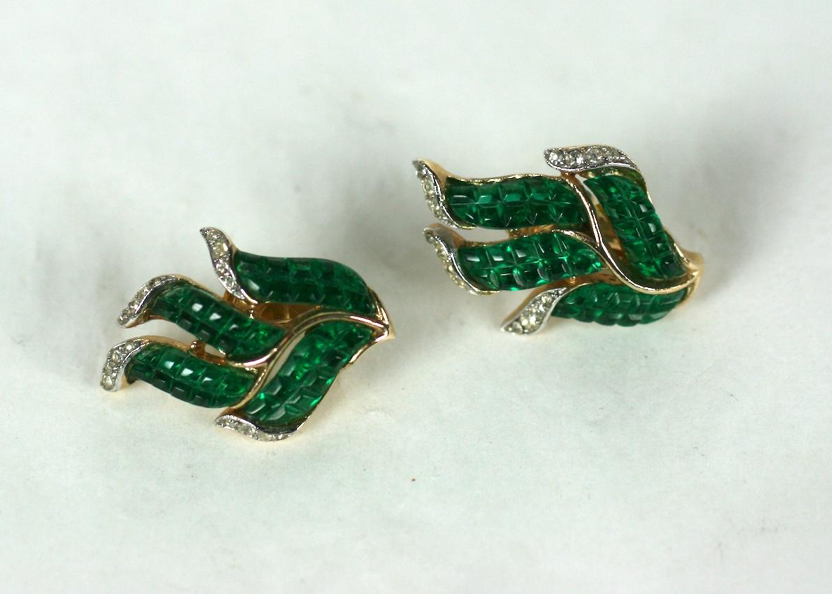 Rare Trifari Alfred Philippe Art Deco style gold plated, crystal rhinestone pave and faux invisibly set emerald leaf ear clips.
Mark dates this to after 1955 - part of a series advertised in June 1961  
Excellent Condition, Marked: Trifari with
