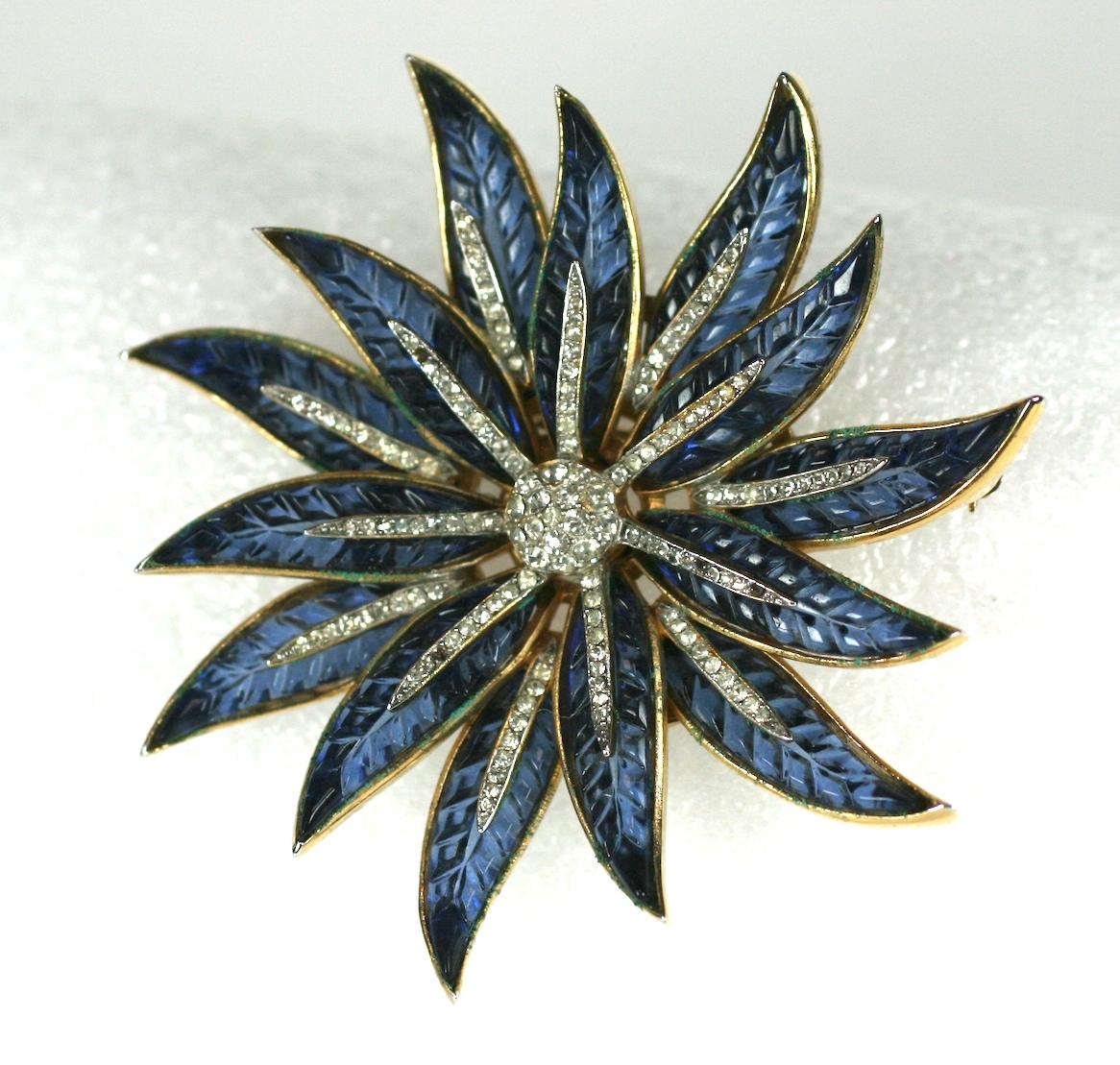 Super rare Trifari 'Alfred Philippe' Gold Pave and Invisibly Set Sapphire Poinsettia Star Flower Pin of gold plated base metal, rhinestones, faux invisibly set sapphires.
Marked: Trifari with Crown. Condition: Excellent
Size: 2.85