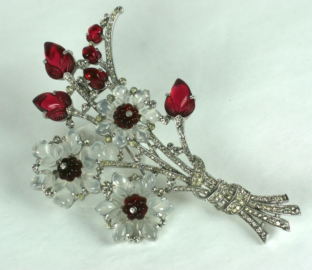 Rare, collectible and massive Trifari Alfred Philippe moonstone and ruby fruit salad giant flower bouquet clip brooch of rhodium plated base metal and crystal rhinestones. Composed of faux ruby jelly mold stones and fruit salad leaves.  The round
