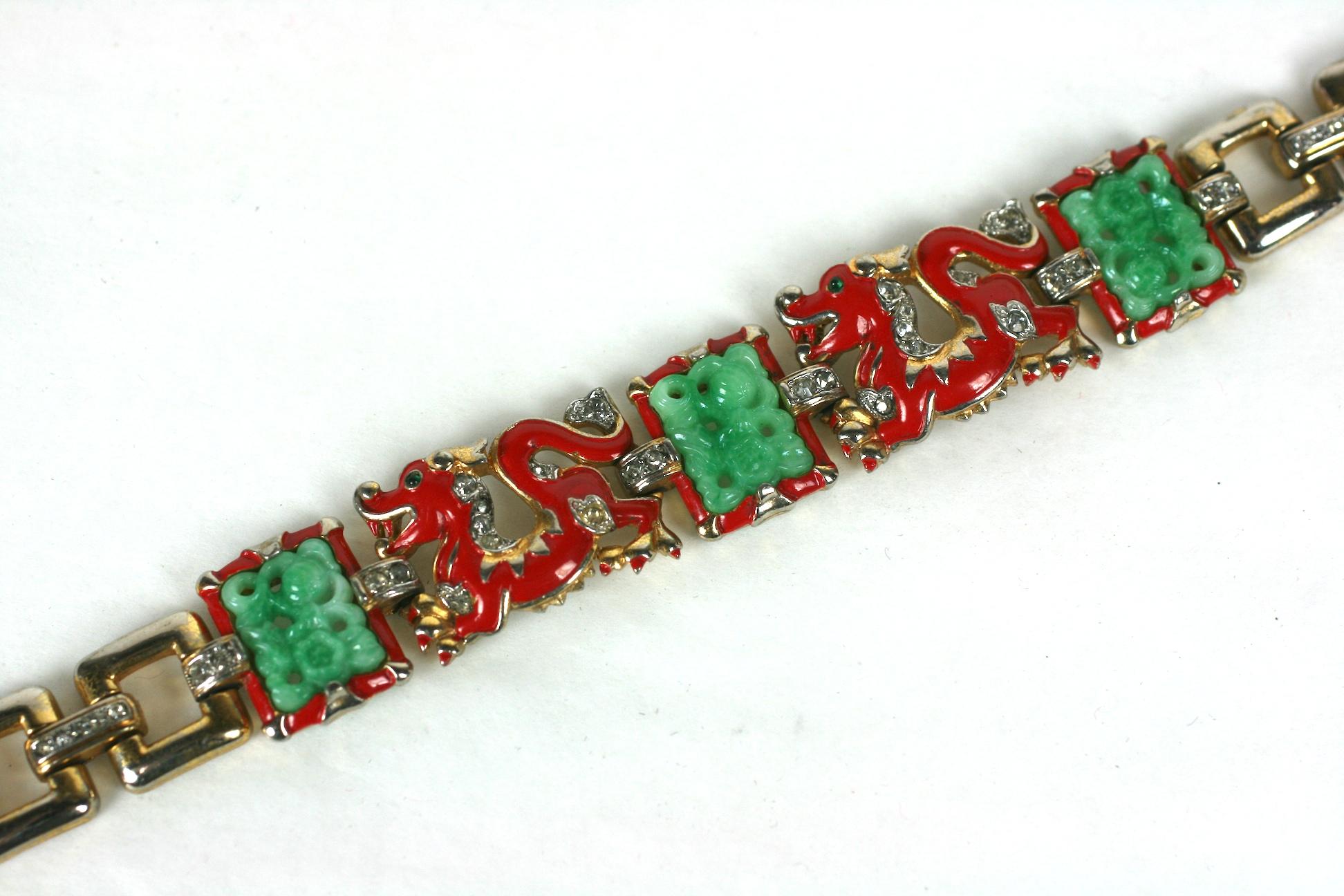 Super Rare and collectible Trifari Alfred Phillipe Ming Dragon Bracelet from the 1930's. 3 faux jade panels are surrounded by red enameled dragons with faux emerald cab eyes. Gilt and pave links form the back. Signed 
