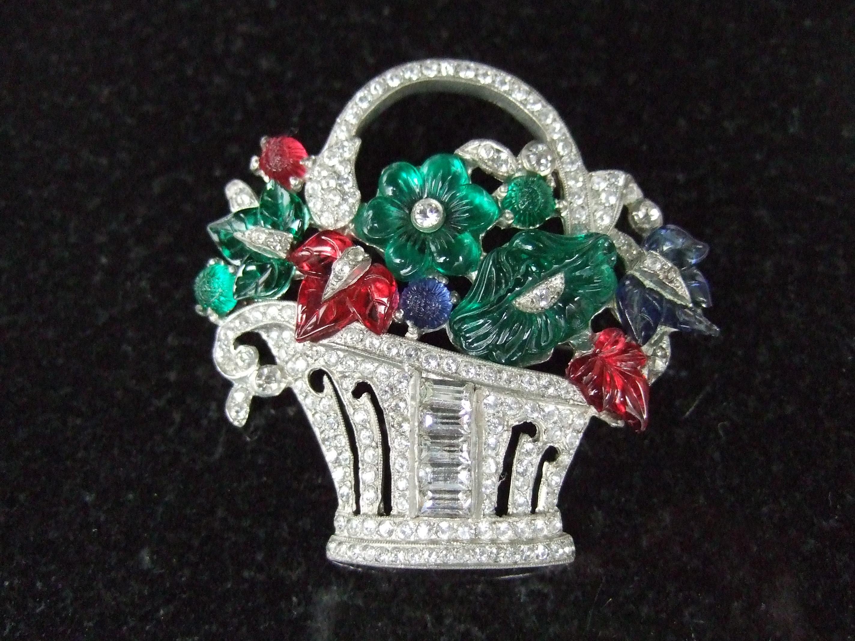 Trifari Art Deco exquisite carved glass fruit salad flower basket brooch c 1930s
Embellished with a collection of jewel tone carved glass flowers
in emerald green, sapphire blue & ruby red colored glass 

Encrusted with rows of glittering clear