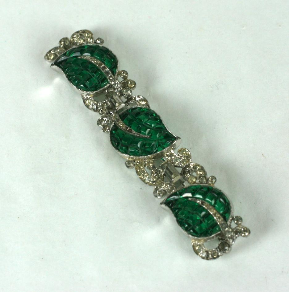 Lovely Trifari Art Deco Invisibly Set Green Leaf Bar brooch by  Alfred Phillipe. Molded glass leaves designed to replicate the invisible settings of Van Cleef Arpels. 
Unsigned TKF, 1930's. 
2.75 x .5