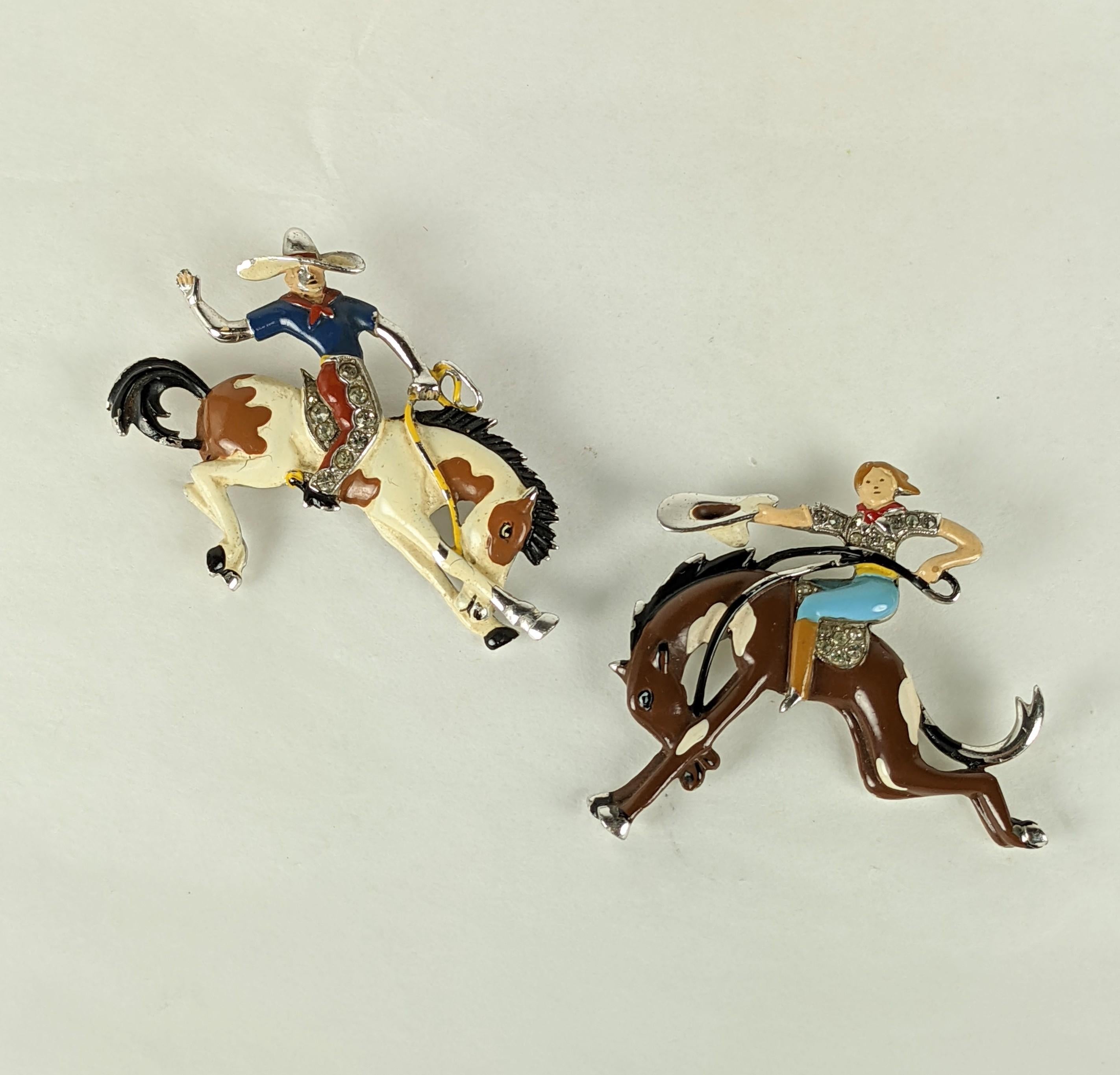 Charming and rare pair of Trifari Art Deco Rodeo Riders by Alfred Phillipe circa 1930's USA. Beautifully detailed cowboy and cowgirl are each posed on a broncing buck, set with pave and enamel. Very rare to have the pair still intact. 
Approx 2
