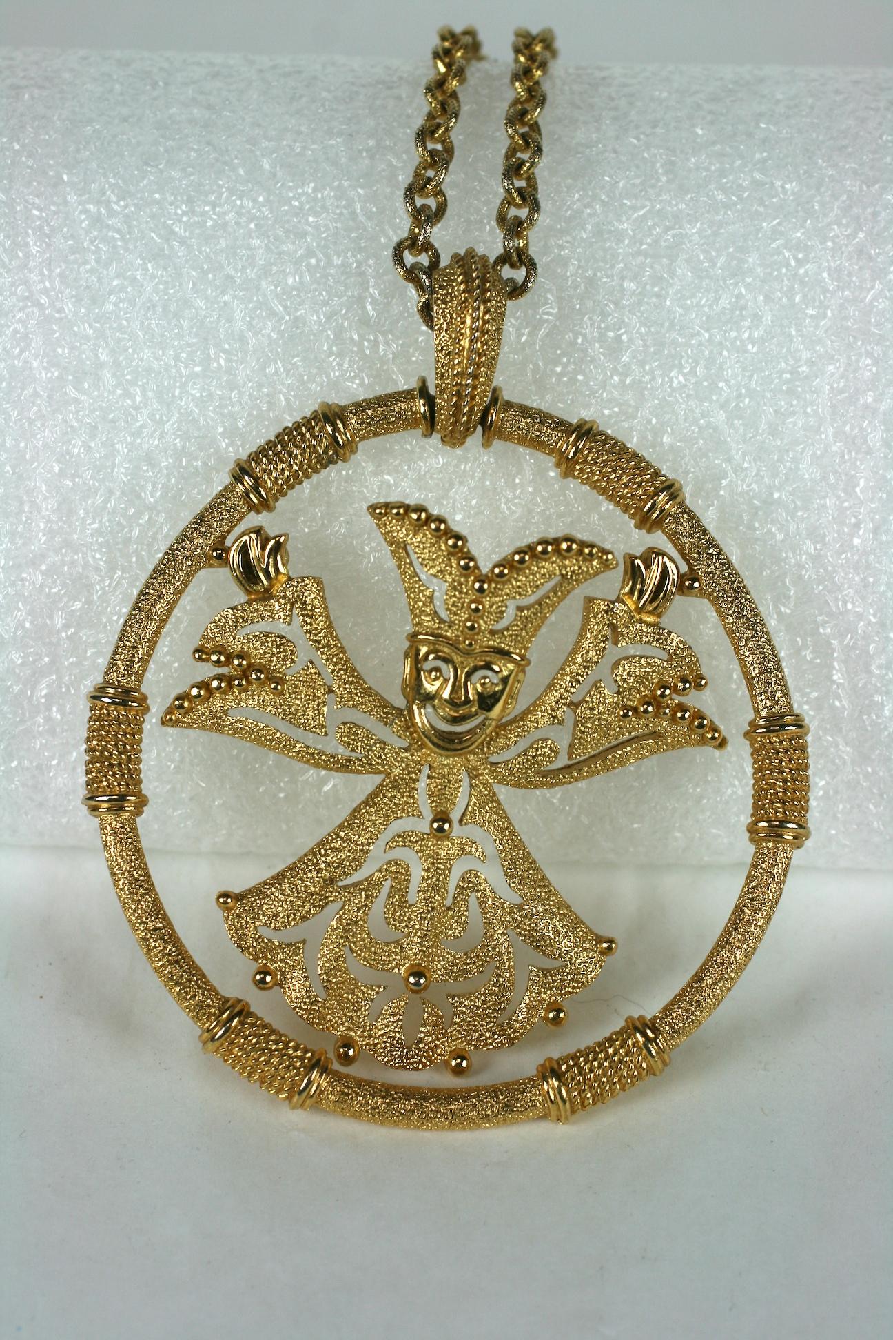 Trifari Articulated Jester Pendant from the 1970's with wild figure set within a textured gilt hoop. Large in scale with unusual motif which swings within pendant.
Chain measures 18
