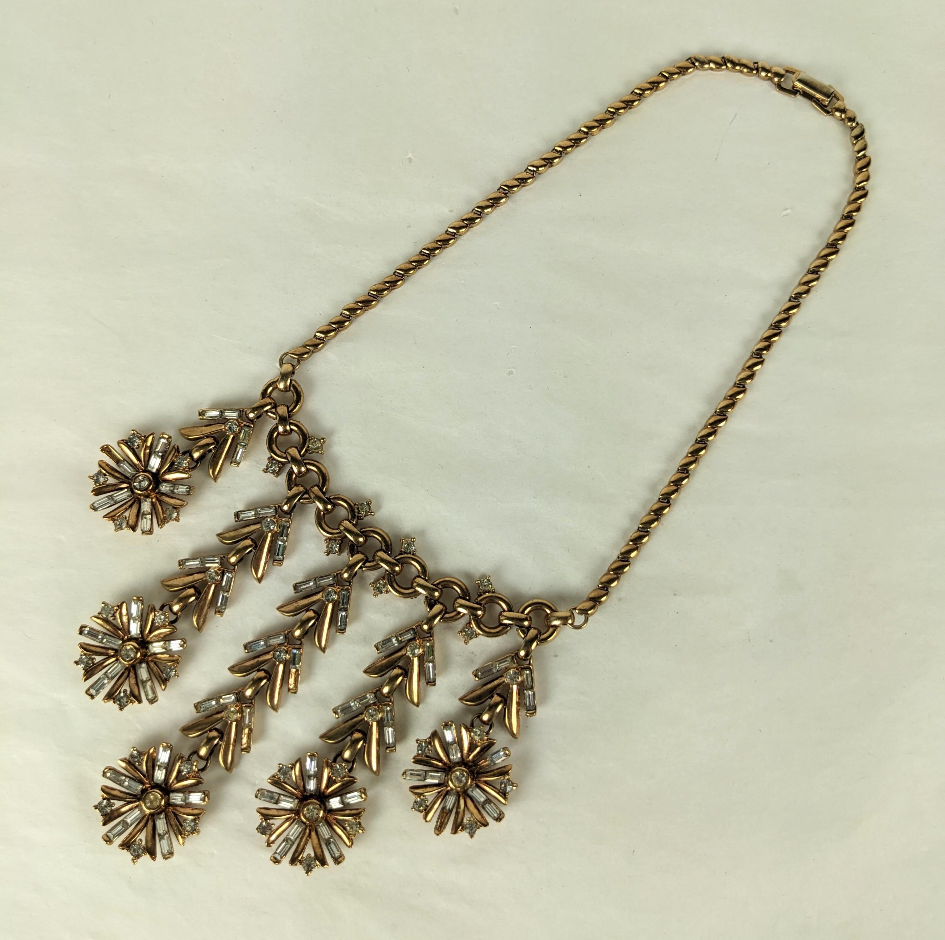 Dramatic Trifari Articulated Snowflake Necklace from the 1940's. Set in pinkish gold vermeil with crystal baguettes. Completely articulated drops. Necklace 15