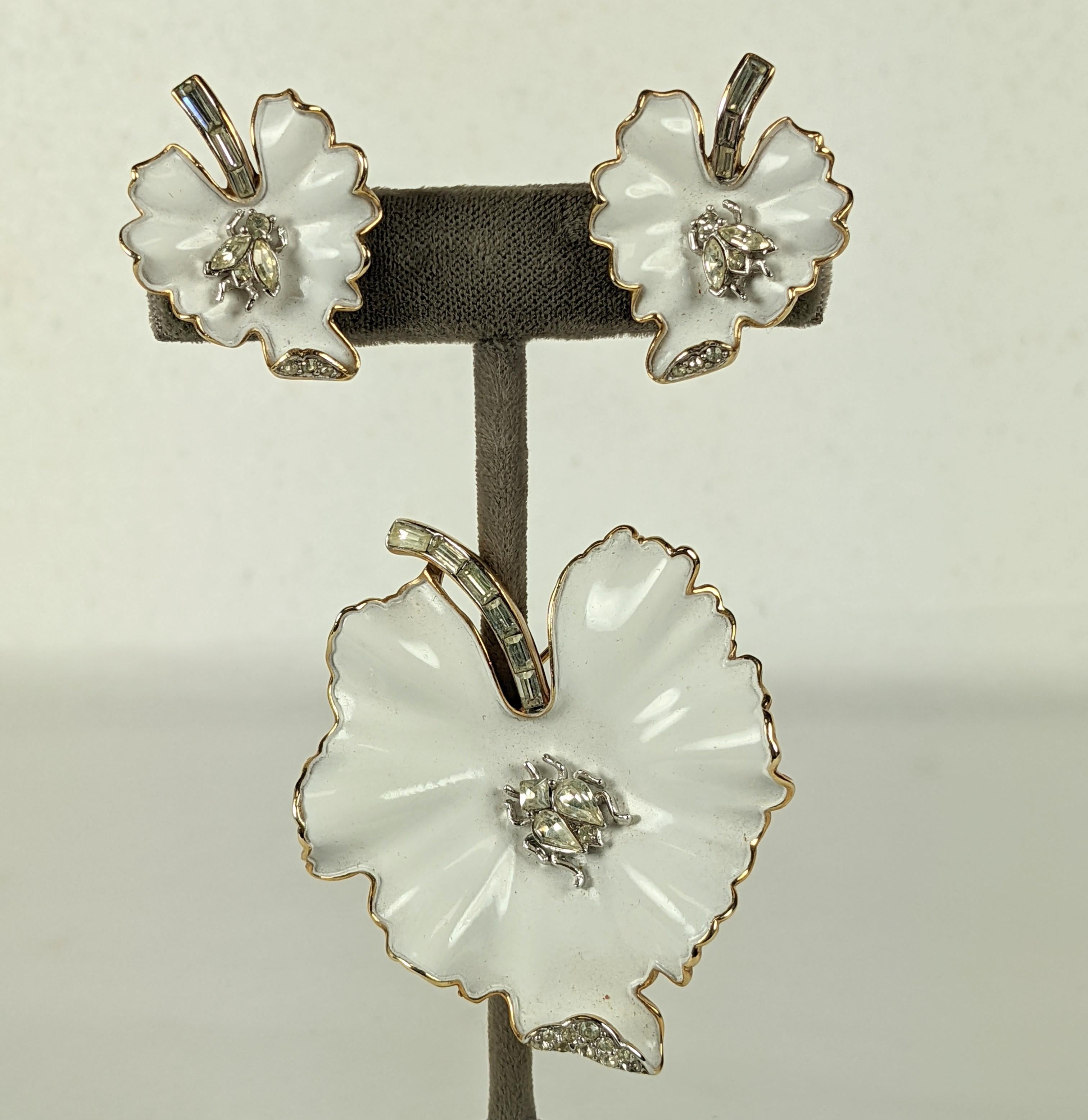 Trifari Bug on Leaf Suite with white enamel from the 1960's. A tiny bug in pastes is set on the brooch and matching earrings. Pave baguette stems. Clip back fittings. 
2.25