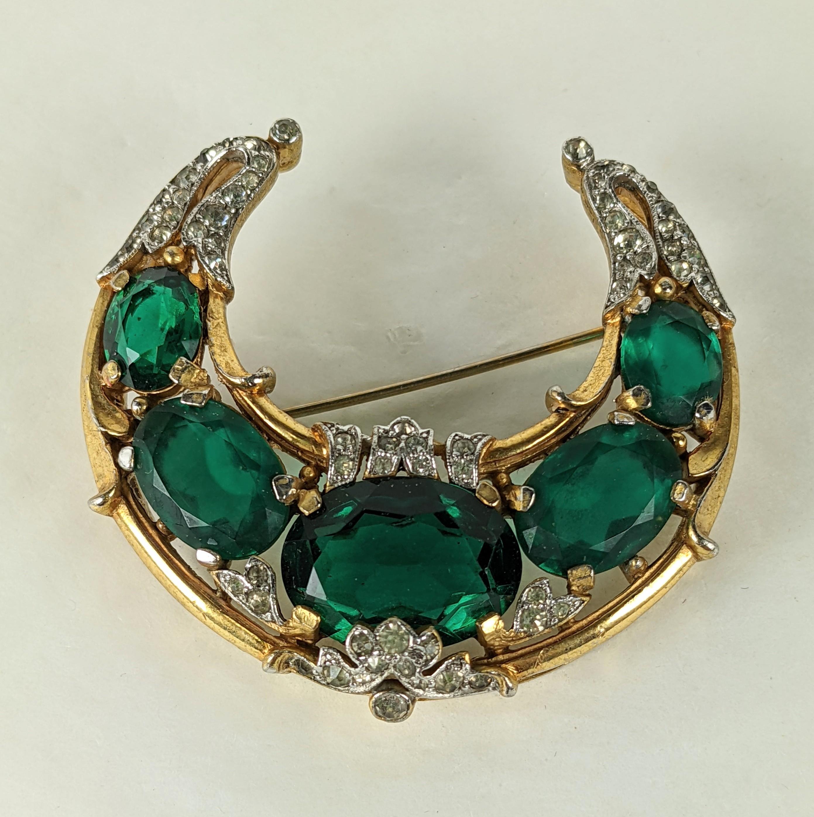 Trifari Empress Eugenie Series Half Moon Crescent Brooch from the 1940's. Half moon design with graduated oval emerald pastes with pave crystal accents by Alfred Phillipe.  Marked 