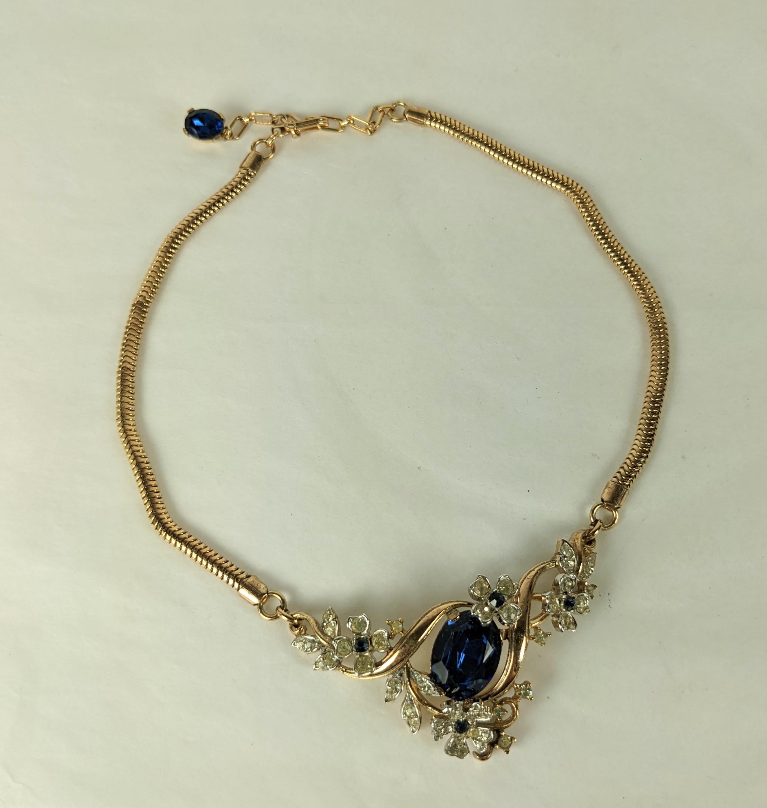 Trifari Eugenie Sapphire Necklace from the 1940's. Pink gold finish with large central sapphire paste with pave flower accents. Signed Trifari.  Length 15