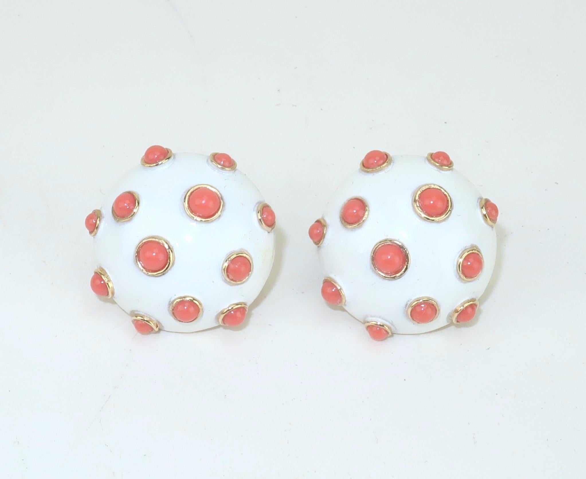 1960's Trifari earbob style clip-on earrings in a white enamel accented by faux coral beads set in gold tone metal.  Hallmarked at the back and outfitted with j-ring shaped clip-on hardware that is comfortable enough for all day wear.  Perfect color