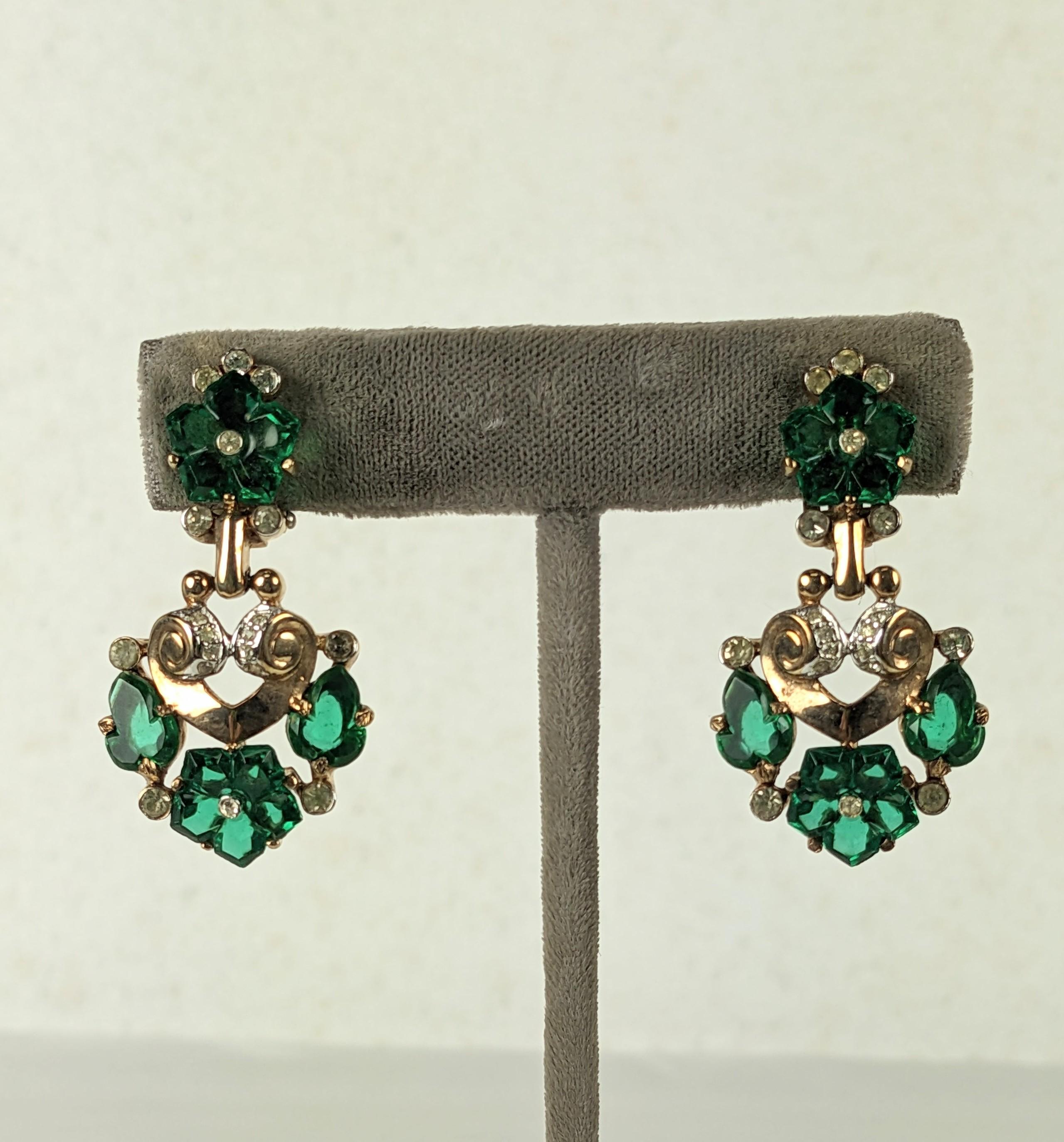Trifari Fleur de Paris Cut Fruit Salad Earrings of faceted faux emerald flowers within a pave and gilt metal articulated setting by Alfred Phillipe.
1950's USA, 1.5