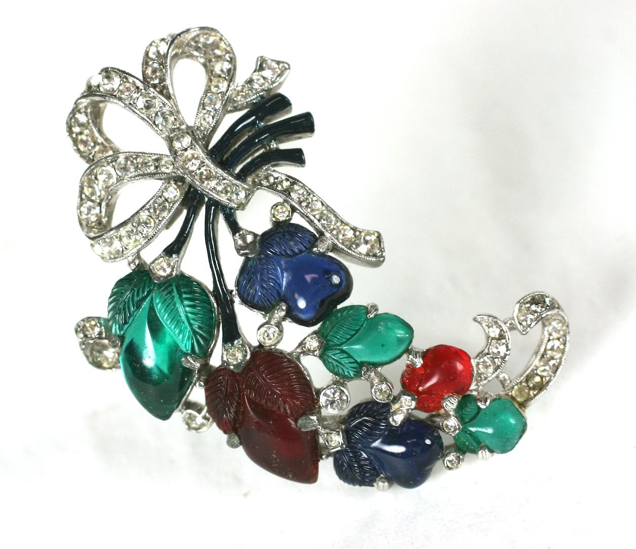 Trifari Alfred Philippe Art Deco primary gem stone colored fruit salad clip brooch. Set in Rhodium plated metal with crystal rhinestone pave bow knot and cold enamel accents.
1930's USA. Excellent Condition.
Length 2 3/8