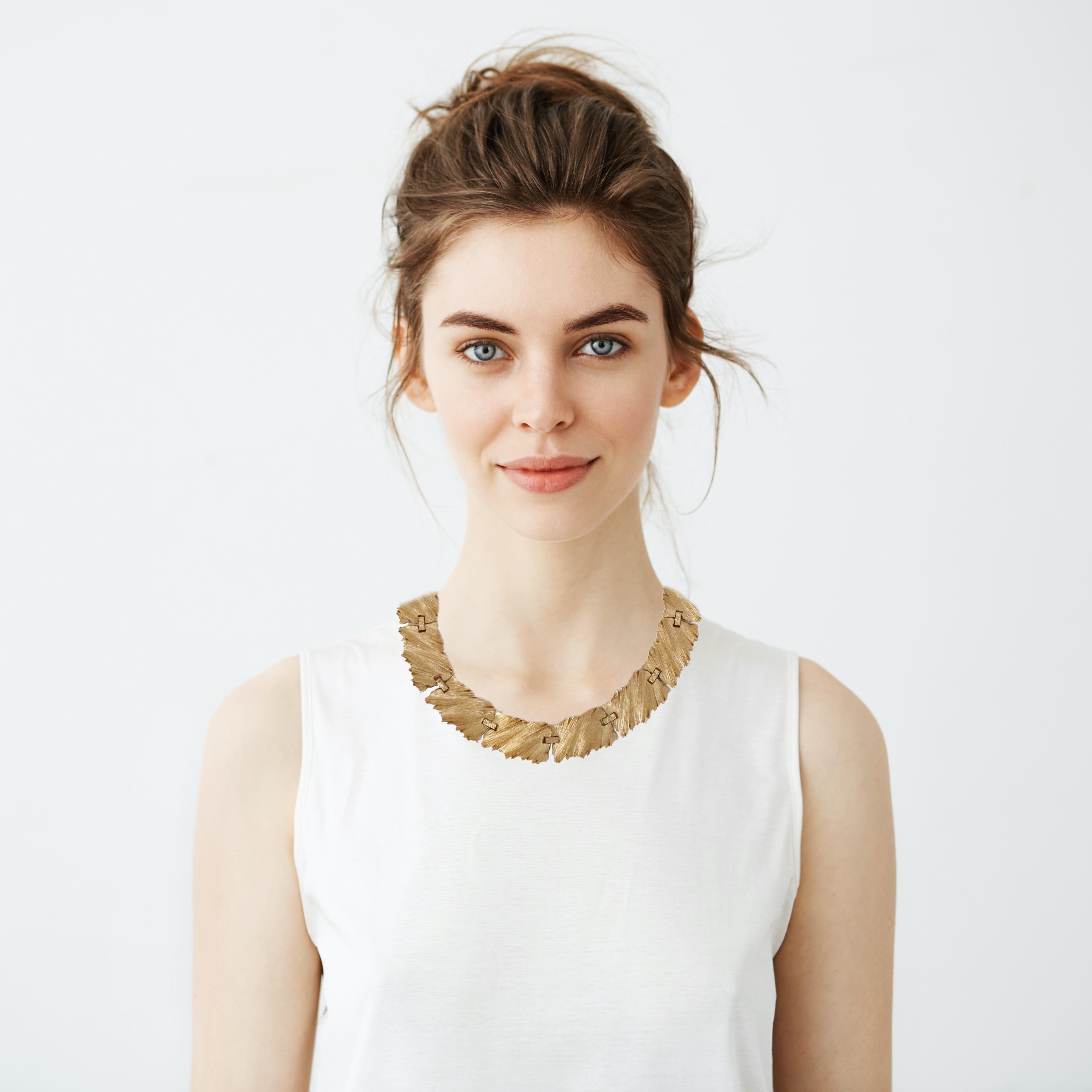 This stunning 1960's Trifari gold-plated Brutalist-style textured panel choker necklace is an amazing statement piece that can be worn alone or layered with other necklaces. Featuring eleven gilded panels, this unique piece is an excellent addition