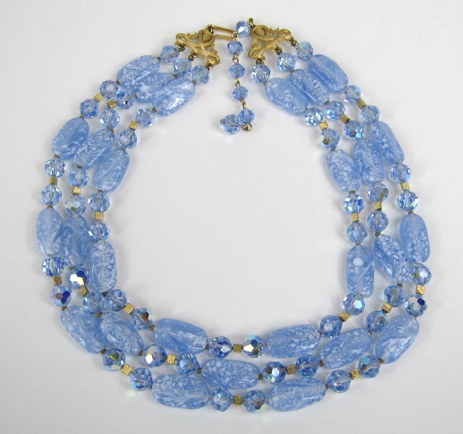A stunning Trifari 3 strand bib Necklace with faceted Auroura Borilias Beads running in between the larger swirled glass beads. Length ranging from 14 inches to 16 inches on the BIB necklace Barrel beads .21.07 mm X 11.50 mm. 8.50mm smaller round