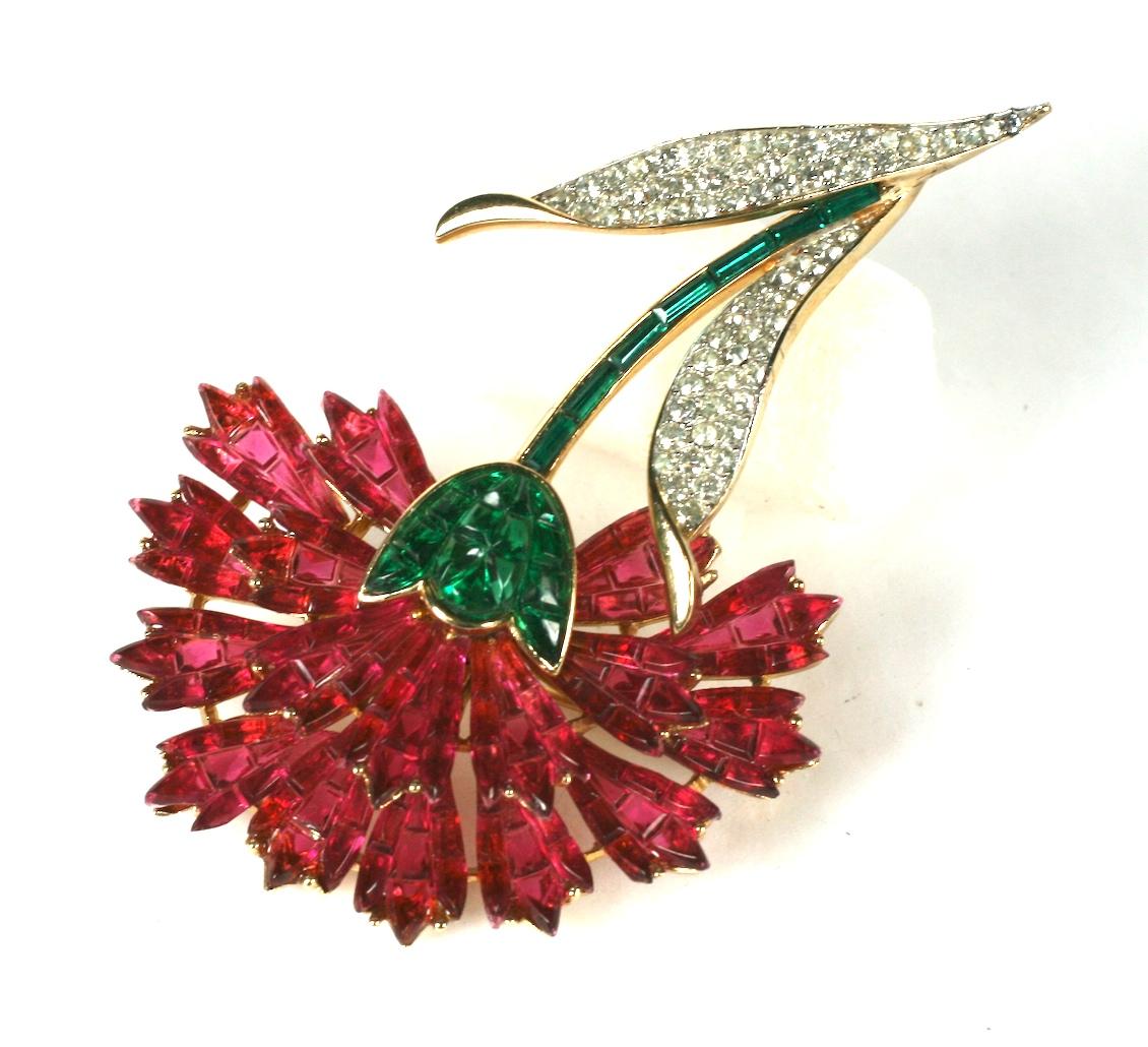 Rare and collectible Trifari Invisibly Set  faux ruby and emerald Carnation from the 1950's. Designed to replicate the invisible settings of Van Cleef and Arpels. 
3.25