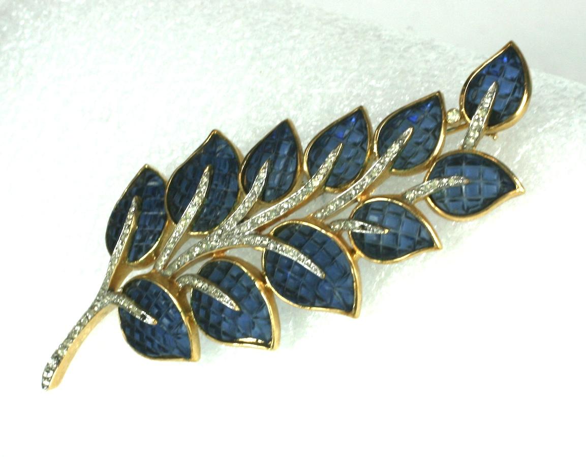 Rare and collectible Trifari Invisibly Set Sapphire Leaf Brooch from the 1960's. Large scale, beautiful quality with leaves molded to replicate Van Cleef and Arpels invisibly settings.
Signed 