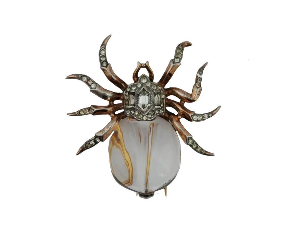 A mid 20th century Trifari costume jewelry clip. The clip is made in a highly detailed spider design with a crystal clear jelly belly and blinding clear stones. Marked, Trifari brand logo, Des. Pat., and numbered 135190, on the backside. Vintage and