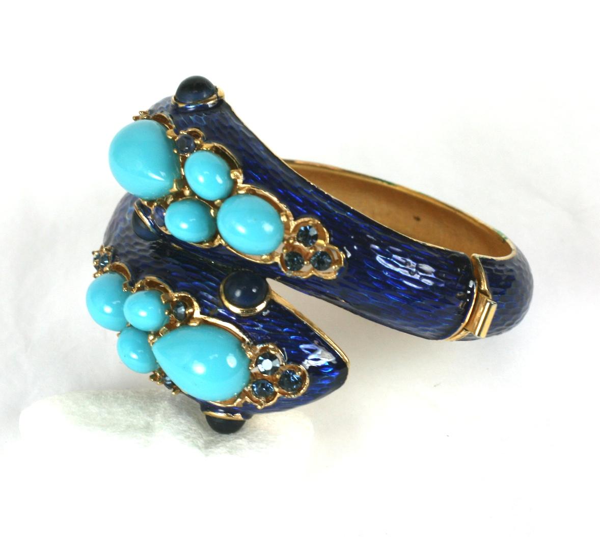 Trifari Bypass Enamel Snake Cuff with large faux turquoises and faux sapphires on a deep blue enamel base. Made in the extravagant style of 1960's David Webb jewelry. 
Side hinge opening. Signed Trifari, circa 1960's USA.
Approx 2